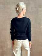 Mature woman wearing designer rachel comey Etla knit top with long sleeves sweetheart neckline in timeless black