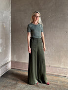 Mature woman  wearing a textured short-sleeve fitted knit top in sage green round neckline with brown heathering