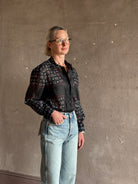 Mature woman wearing designer brand Rachel Comey long sleeve paisley print button down shirt semi-transparent