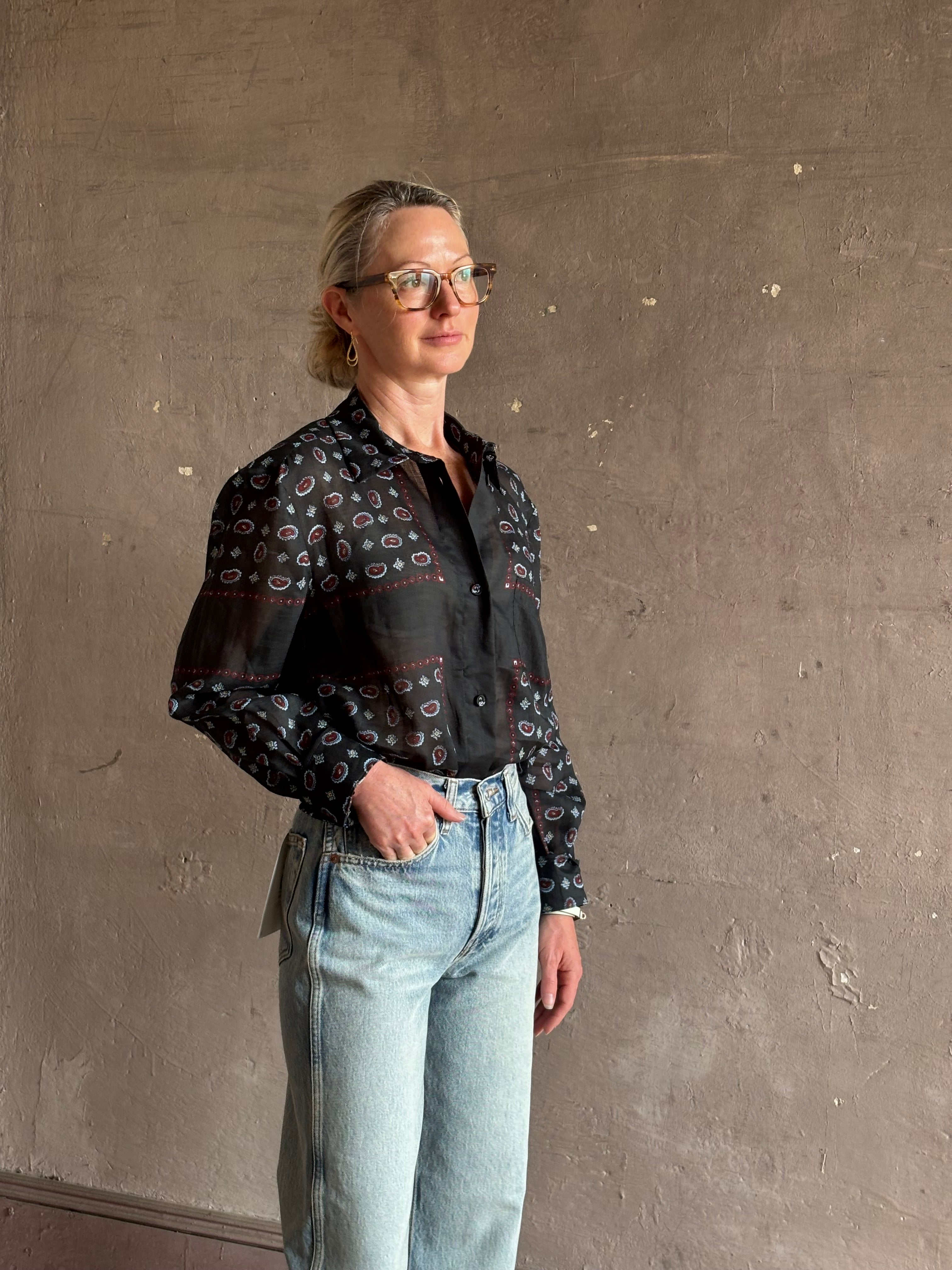 Mature woman wearing designer brand Rachel Comey long sleeve paisley print button down shirt semi-transparent