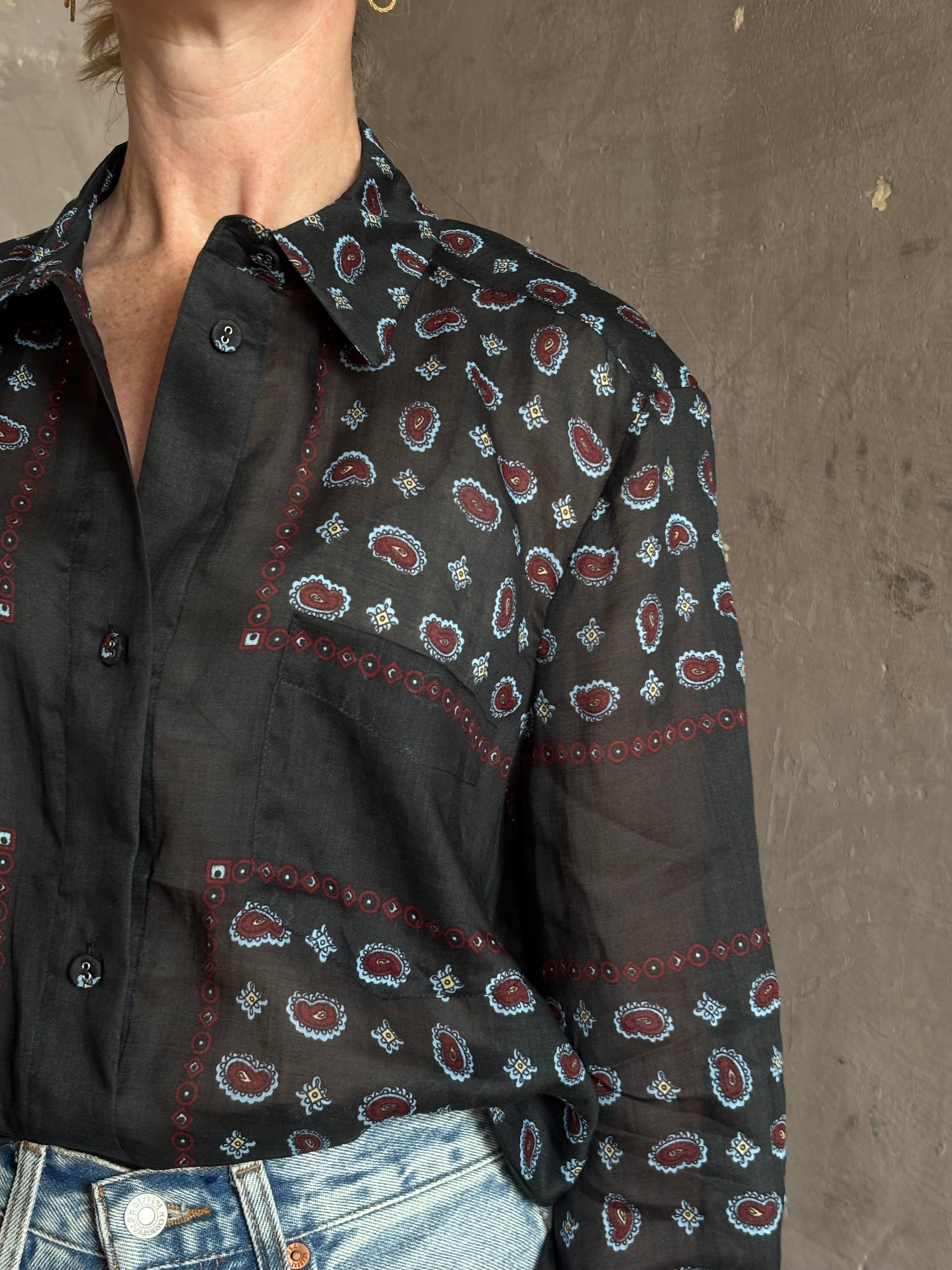 Mature woman wearing designer brand Rachel Comey long sleeve paisley print button down shirt semi-transparent