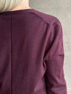 Mature woman wearing Rachel Comey long sleeve burgundy cardigan leightweight plunging v-neck layering