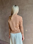 Mature woman wearing Rachel Comey long sleeve caramel cardigan leightweight plunging v-neck layering
