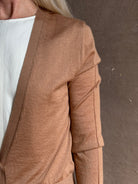 Mature woman wearing Rachel Comey long sleeve caramel cardigan leightweight plunging v-neck layering