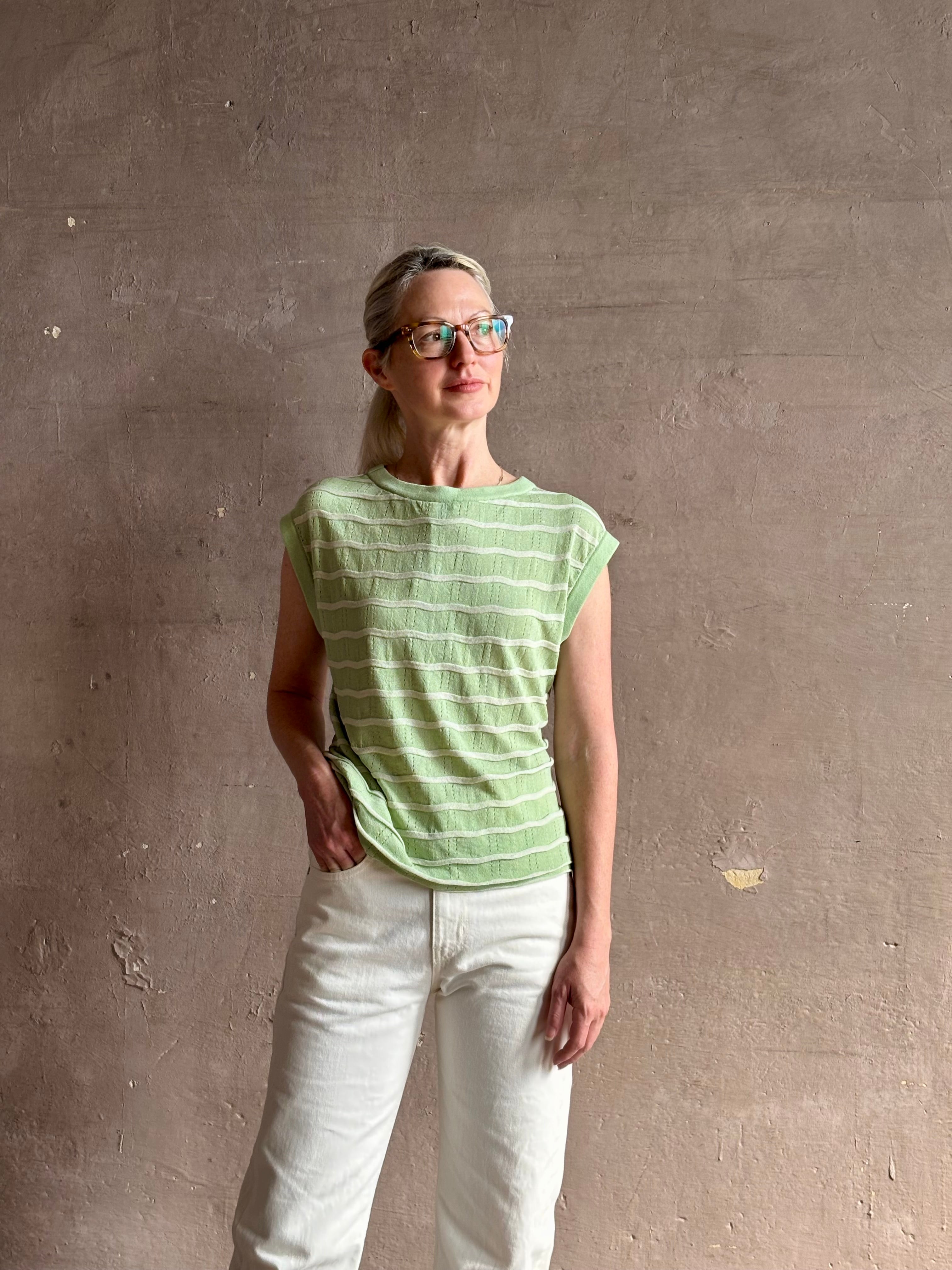 Mature woman wearing light green white horizontally striped Rachel Comey top  gathered twist waist detail reversable