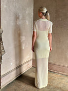 mature woman wearing Rag and bone Sheath cream maxi Dress open knit with slip slim-fit polo short sleeve side slits 