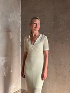 woman wearing Rag and bone Sheath cream maxi Dress open knit with slip slim-fit polo short sleeve side slits v-neck