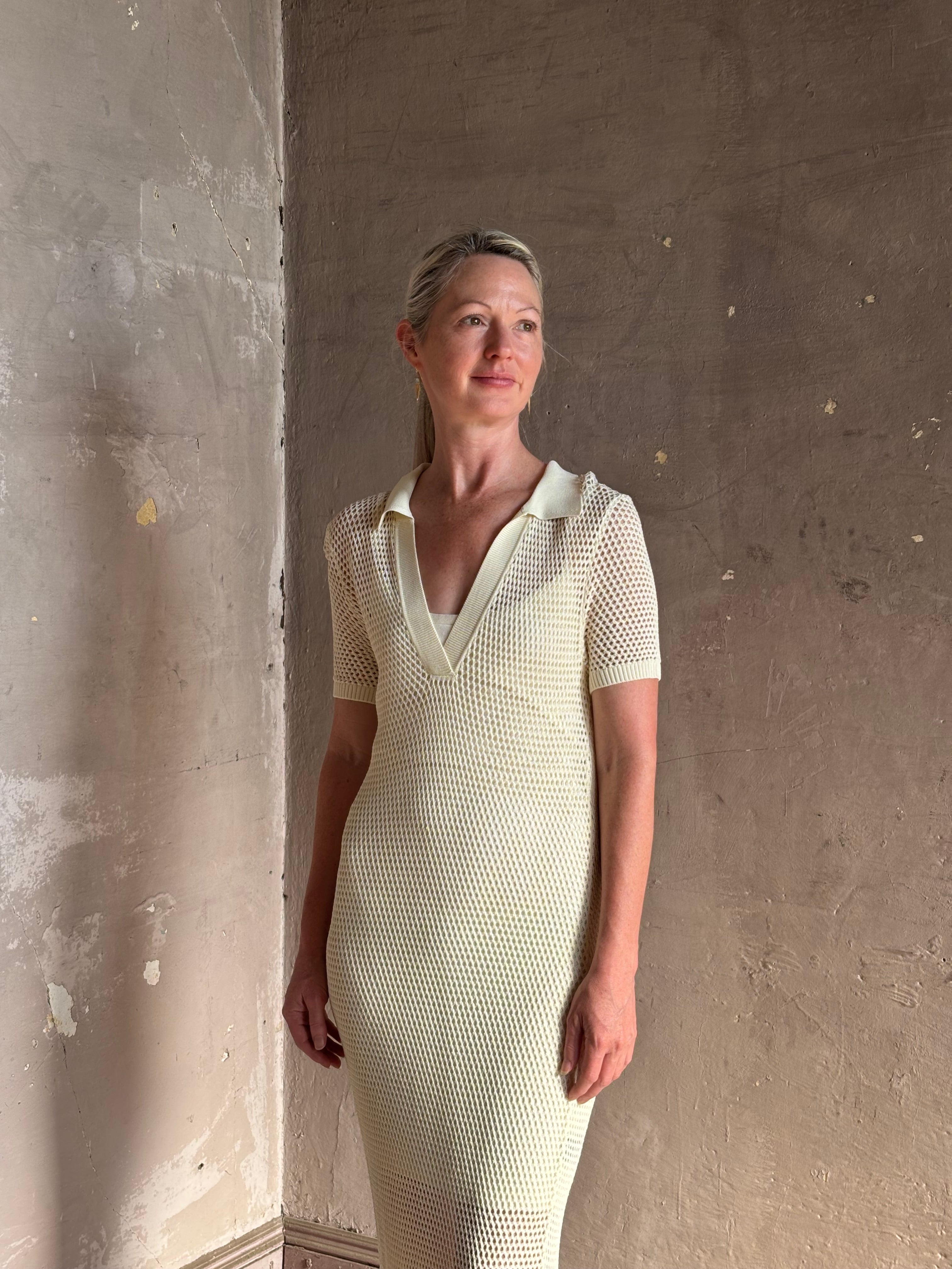woman wearing Rag and bone Sheath cream maxi Dress open knit with slip slim-fit polo short sleeve side slits v-neck