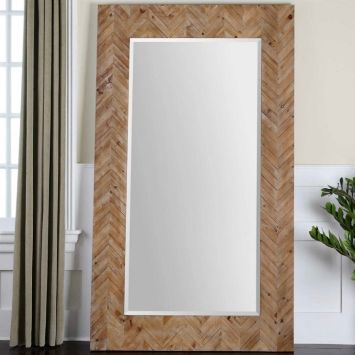 An oversized large rectangular beveled glass mirror with a wood frame, featuring a herringbone pattern.