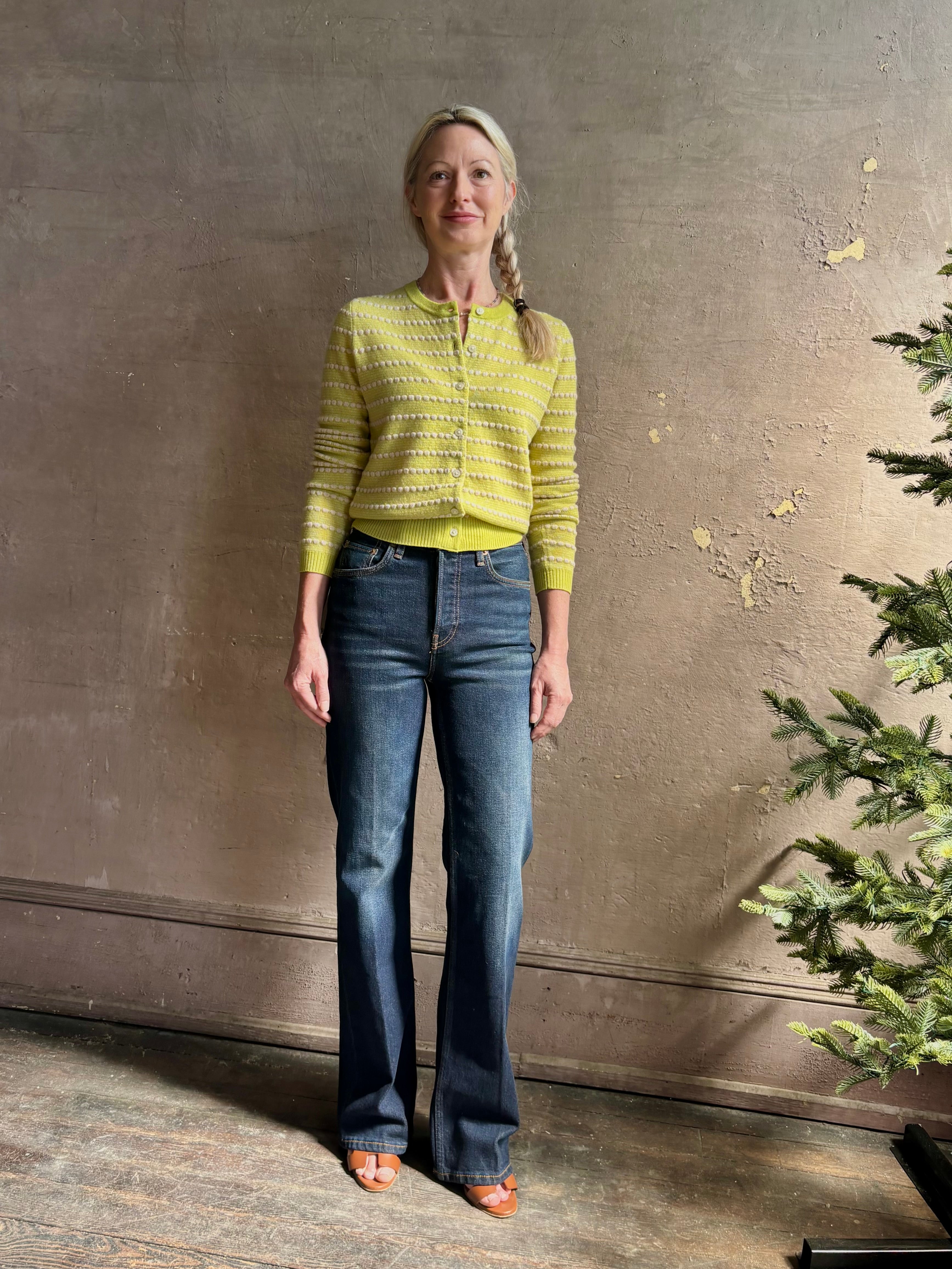 Woman wearing REDONE 70s Bootcut Denim in a dark blue wash with comfort stretch zip closure finished hem and 10.75" rise