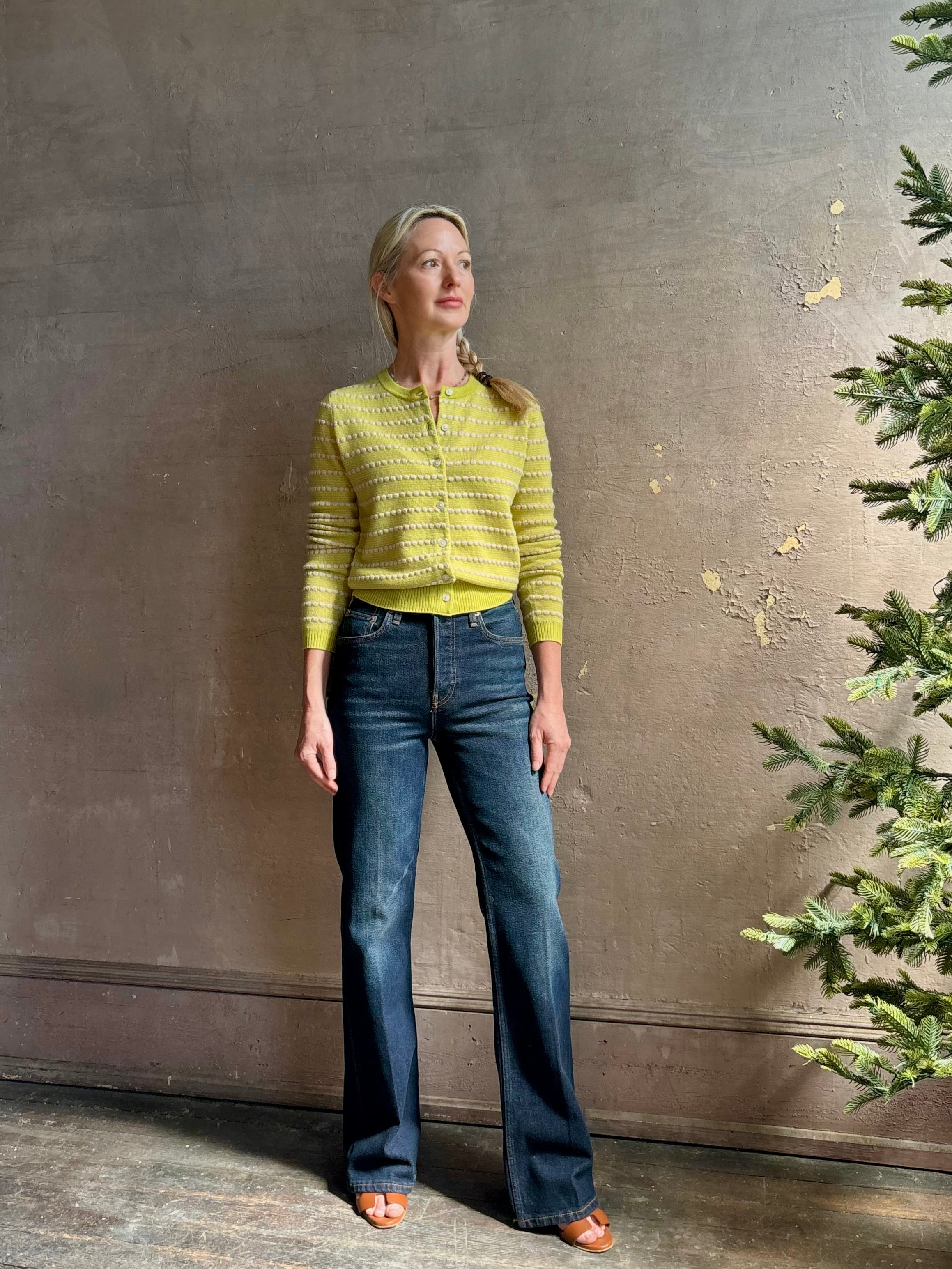 Woman wearing REDONE 70s Bootcut Denim in a dark blue wash with comfort stretch zip closure finished hem and 10.75" rise