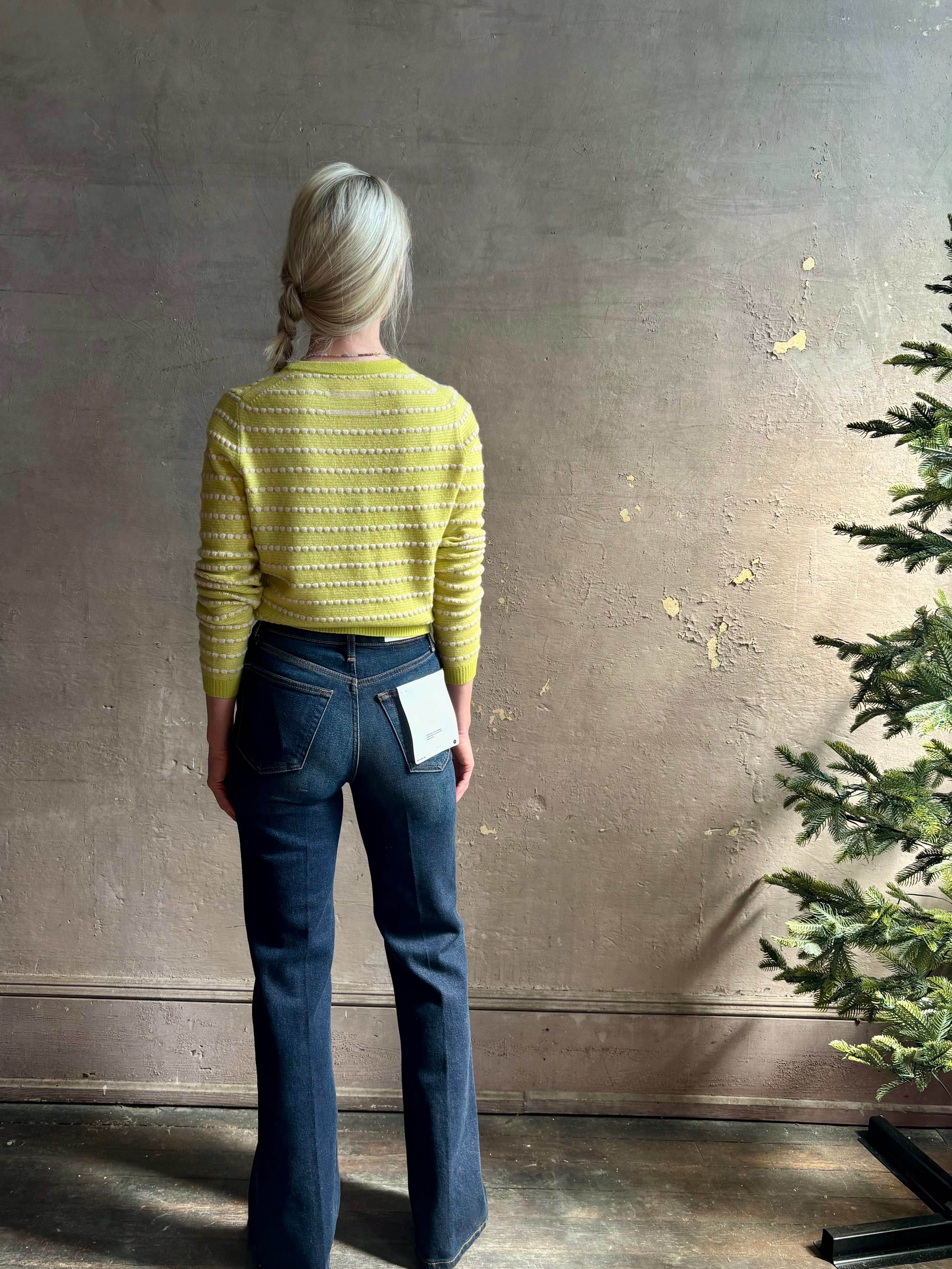 Woman wearing REDONE 70s Bootcut Denim in a dark blue wash with comfort stretch zip closure finished hem and 10.75" rise