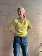 Woman wearing REDONE 70s Bootcut Denim in a dark blue wash with comfort stretch zip closure finished hem and 10.75" rise