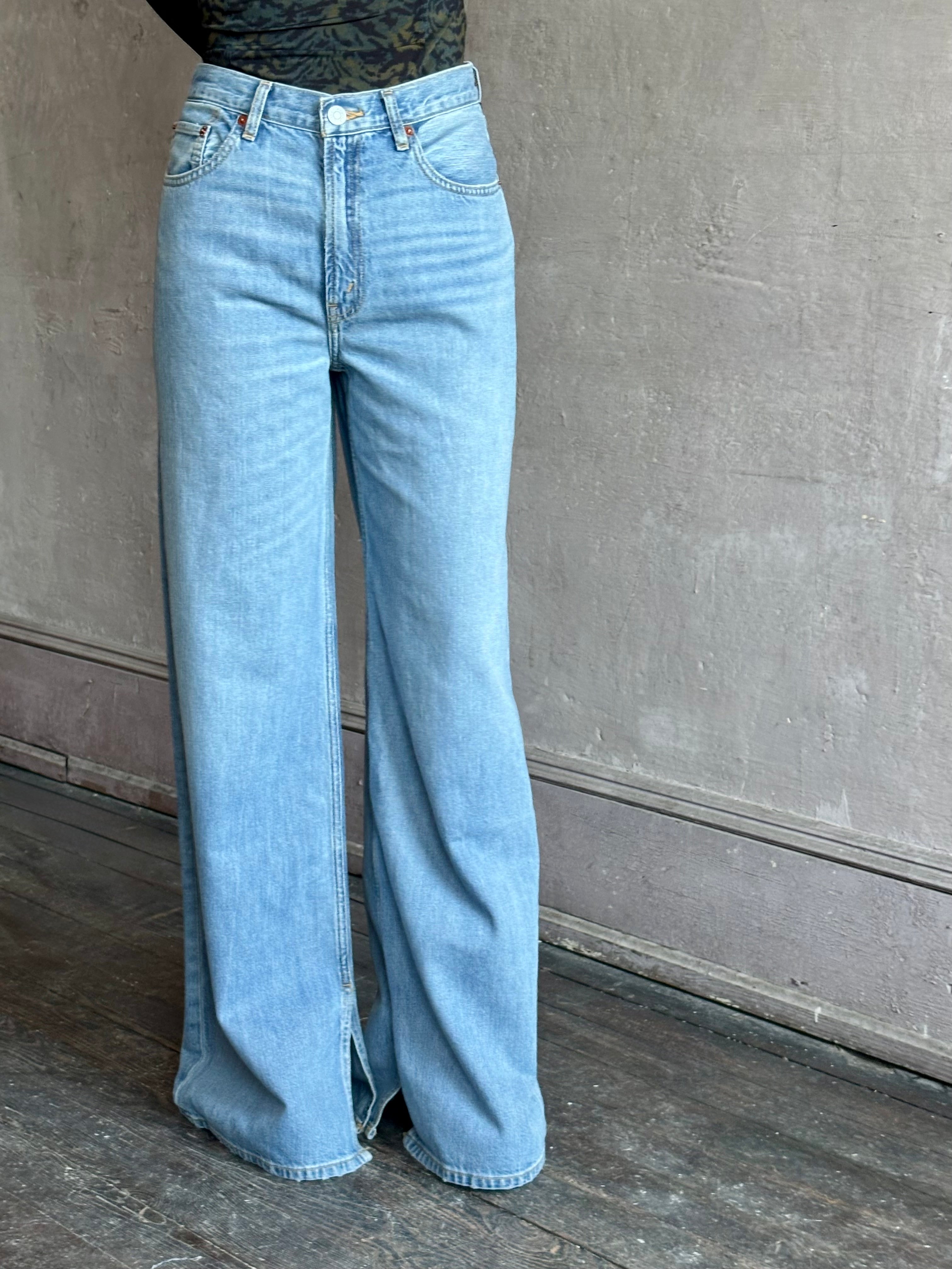 Woman wearing the Low Rider Loose Jean from Re/Done is  a thoroughly modern cool girl silhouette rendered in Hacienda wash and crafted from 100% cotton with wide leg and inside vent