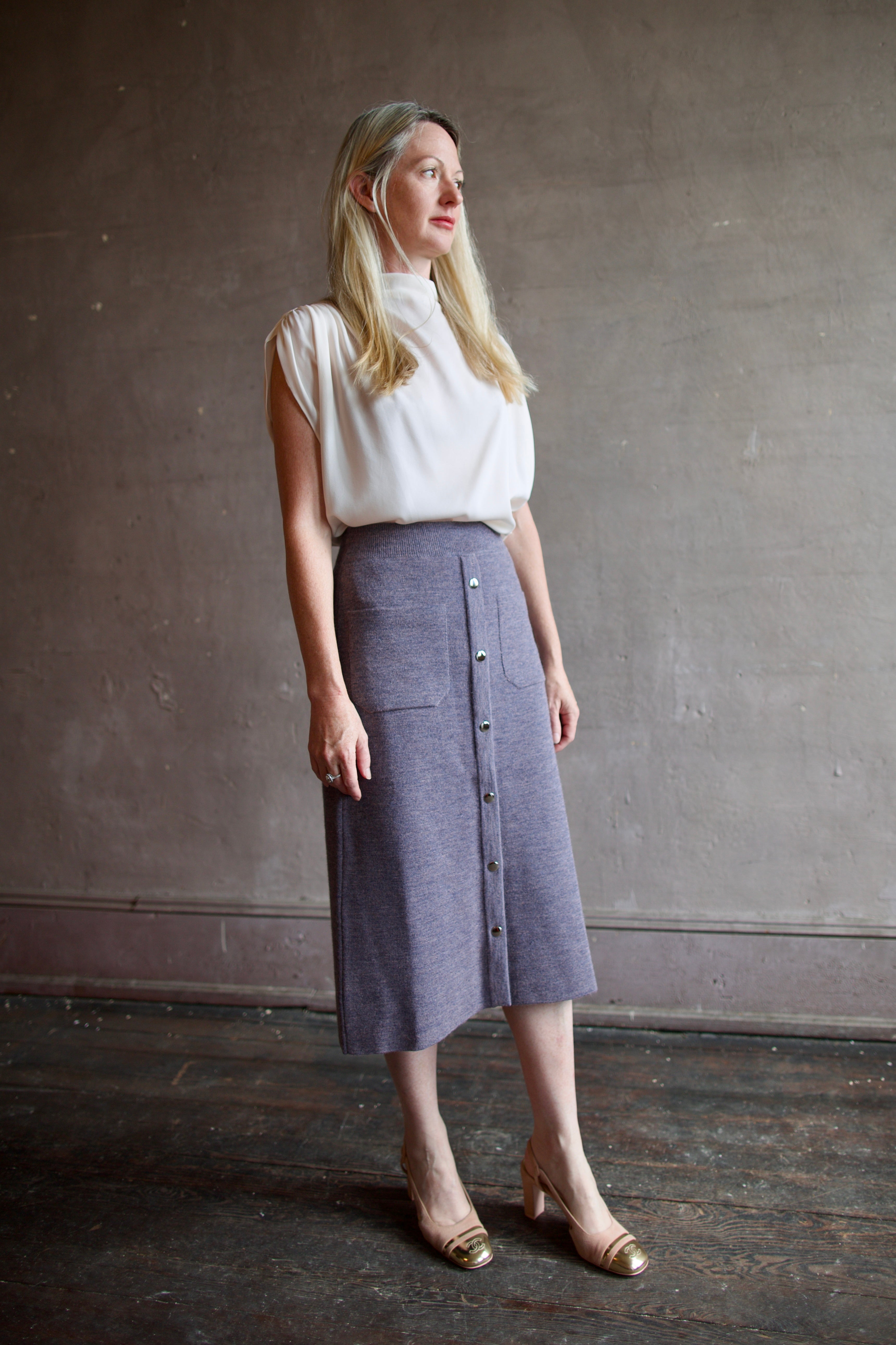 Mature model wearing a quality lilac knit skirt fabricated from baby alpaca by designer Rachel Comey
