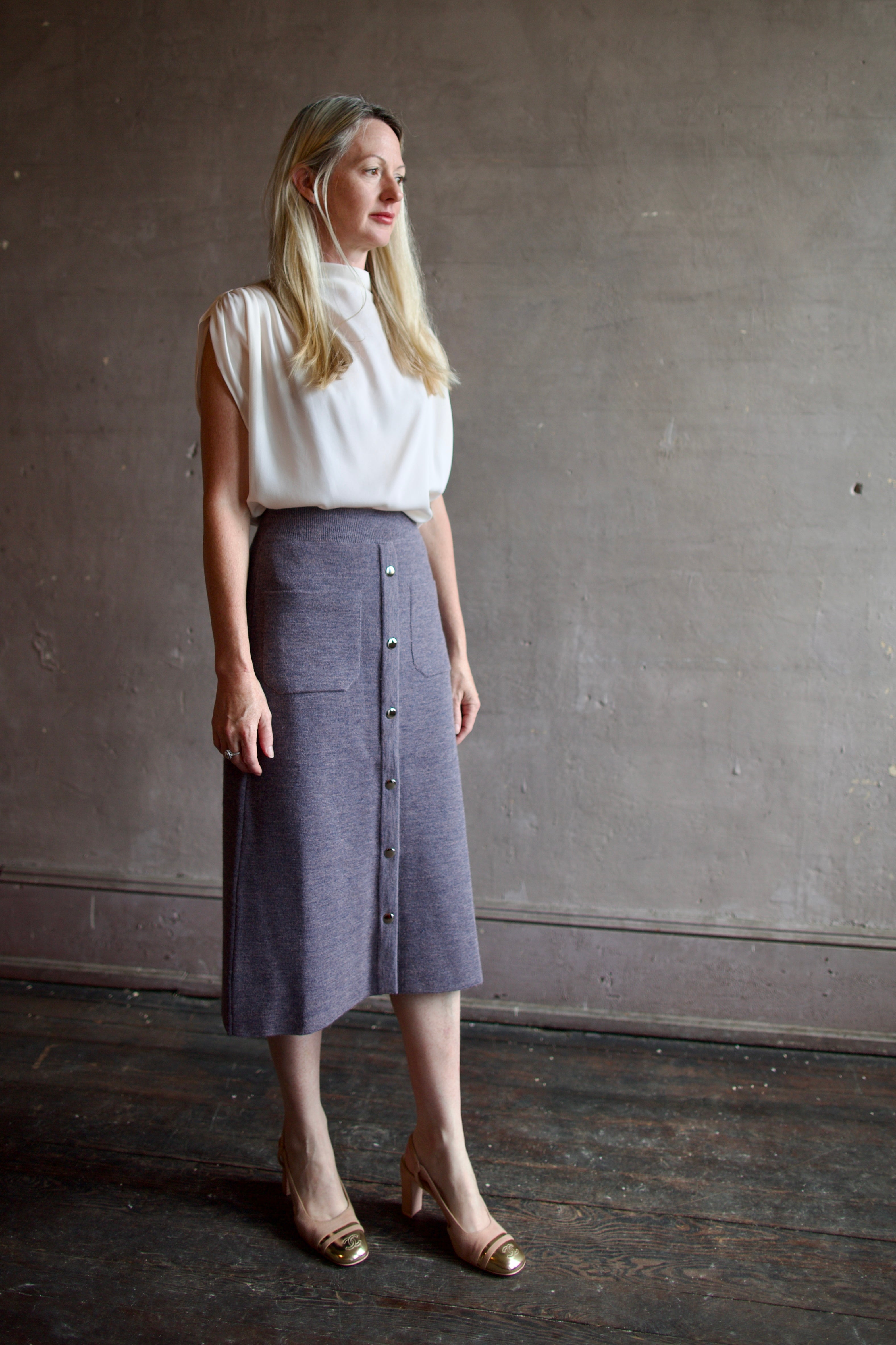 Mature model wearing a quality lilac knit skirt fabricated from baby alpaca by designer Rachel Comey