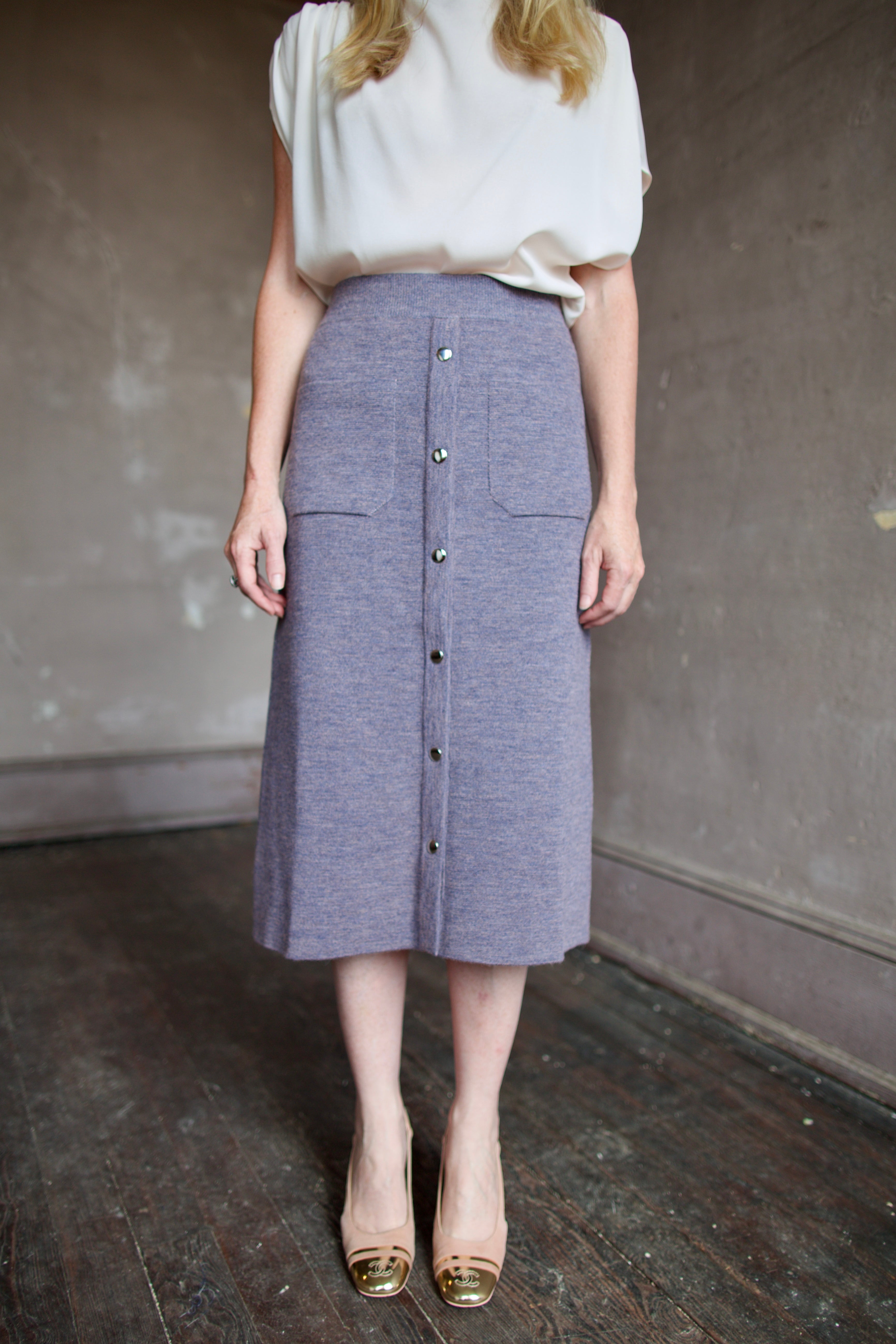 Mature model wearing a quality lilac knit skirt fabricated from baby alpaca by designer Rachel Comey