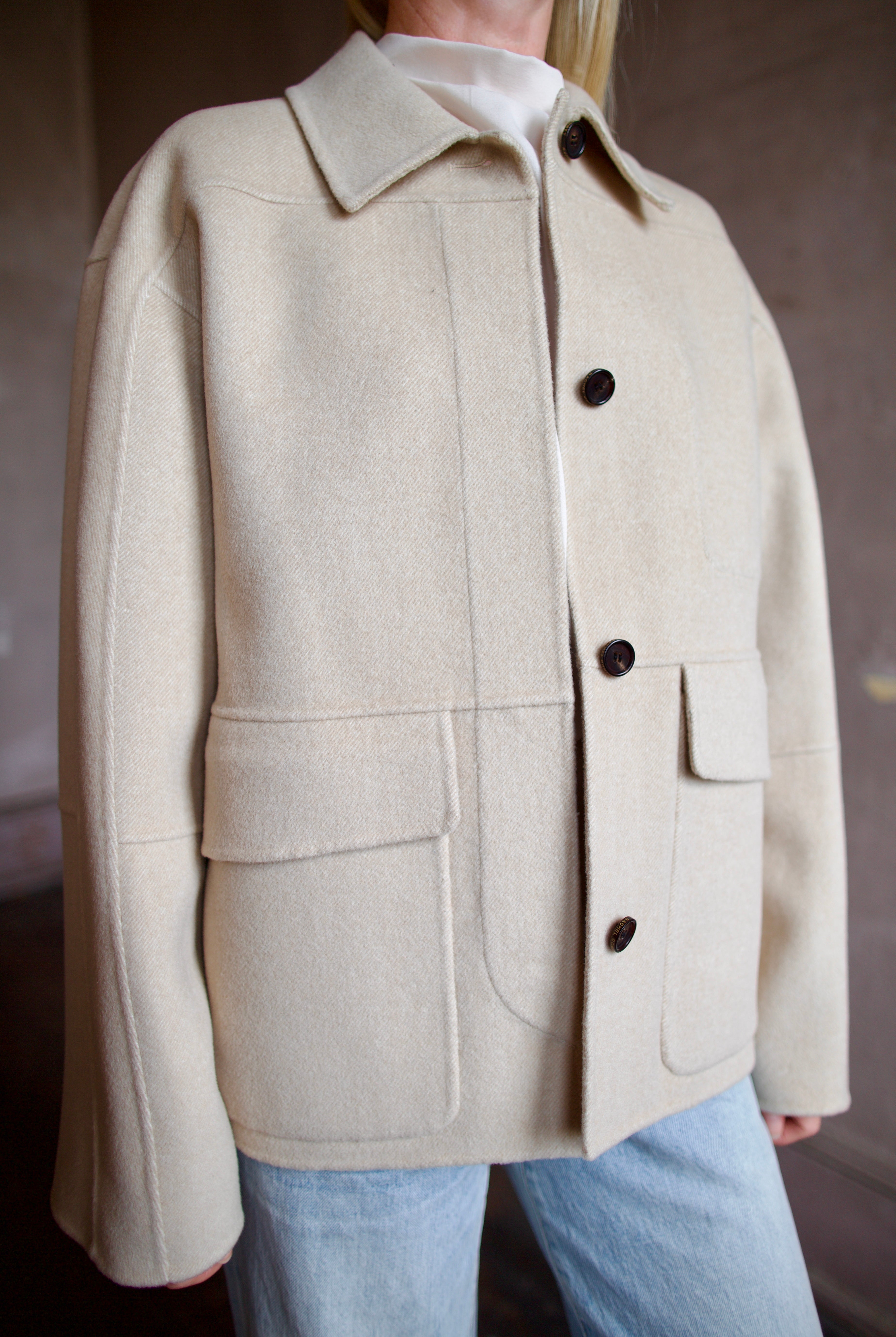 Model wearing a timeless beige cashmere coat by Rachel Comey