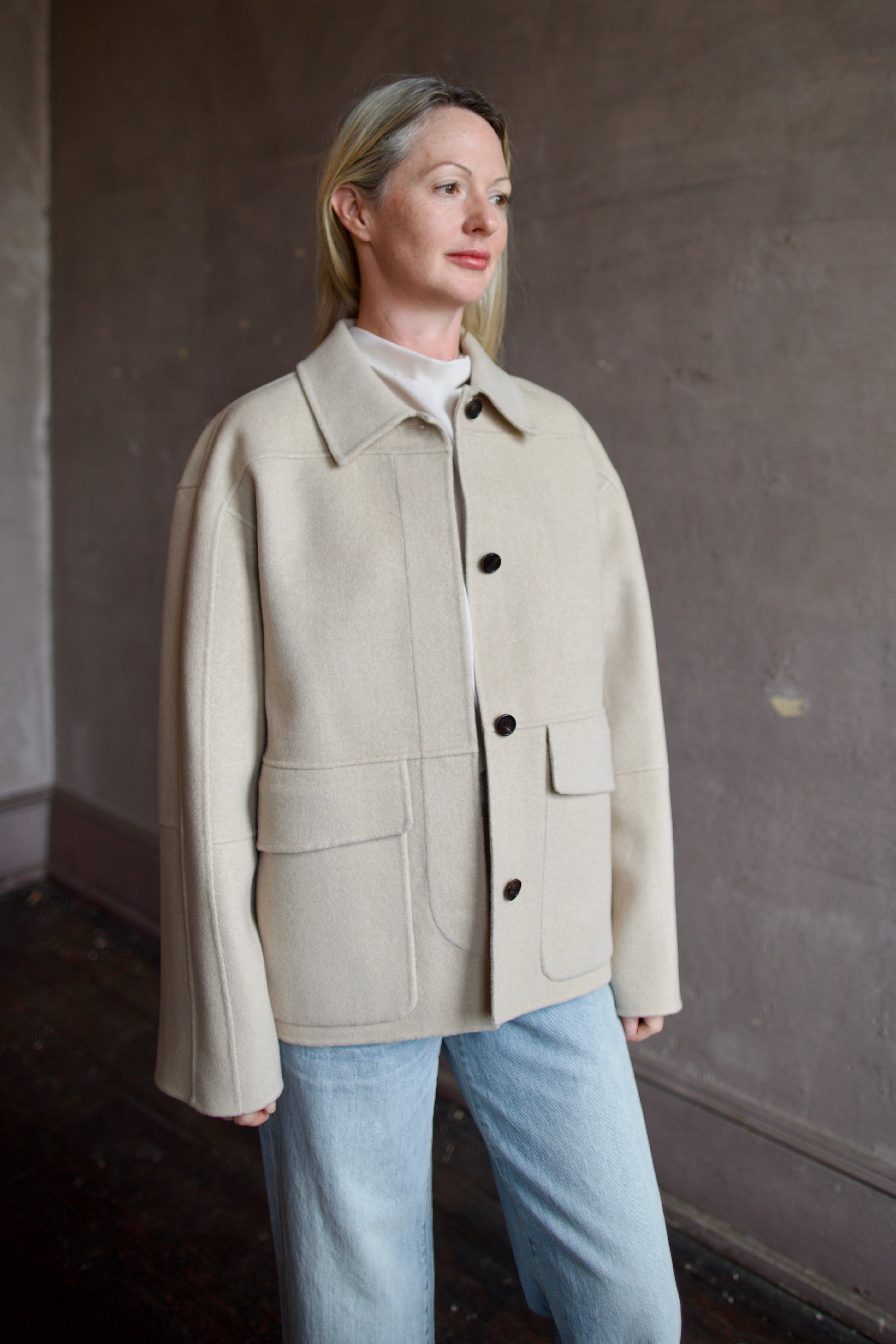 Model wearing a timeless beige cashmere coat by Rachel Comey