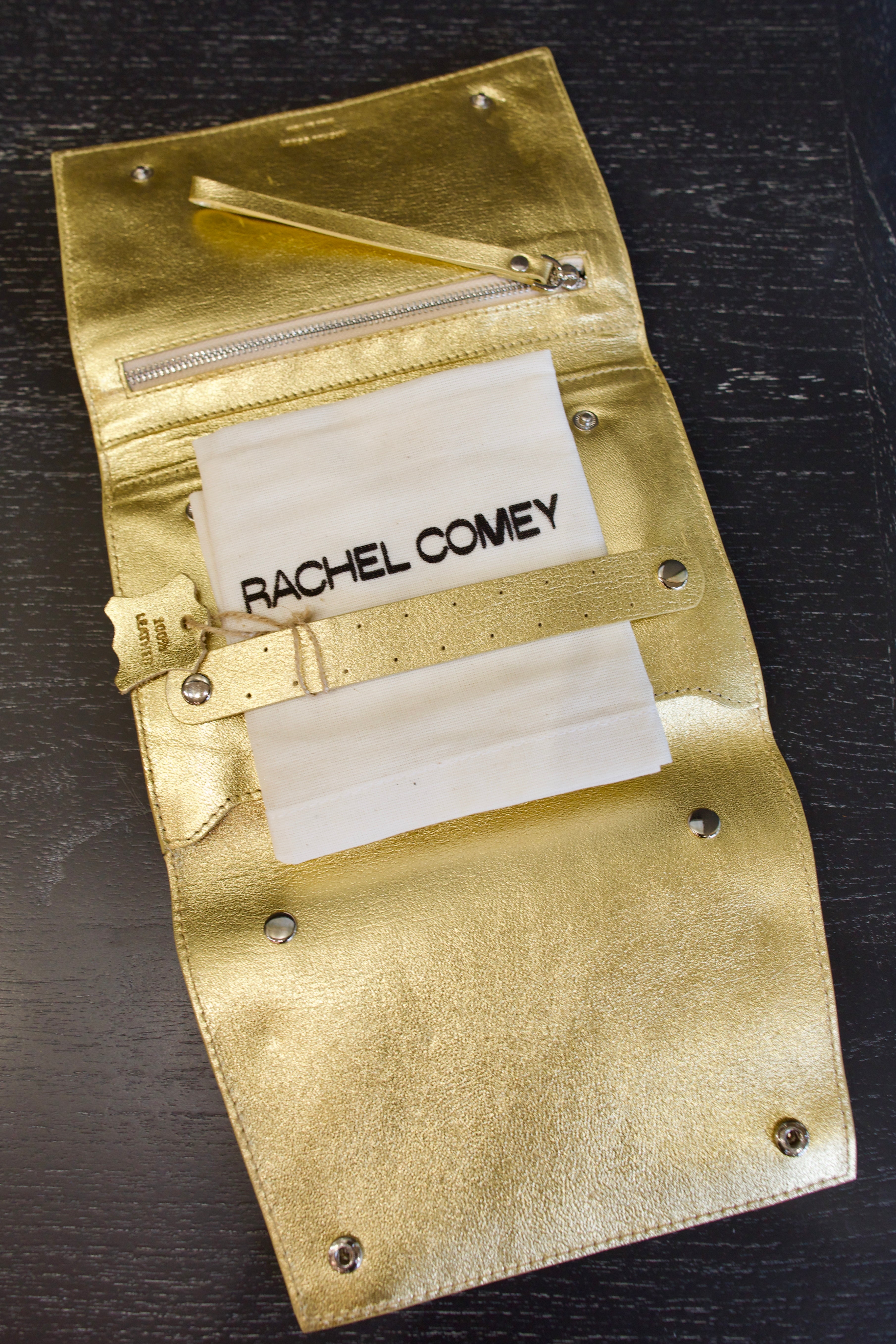 Photo of a gold metallic Rachel Comey leather jewelry travel case with multiple storage compartments 