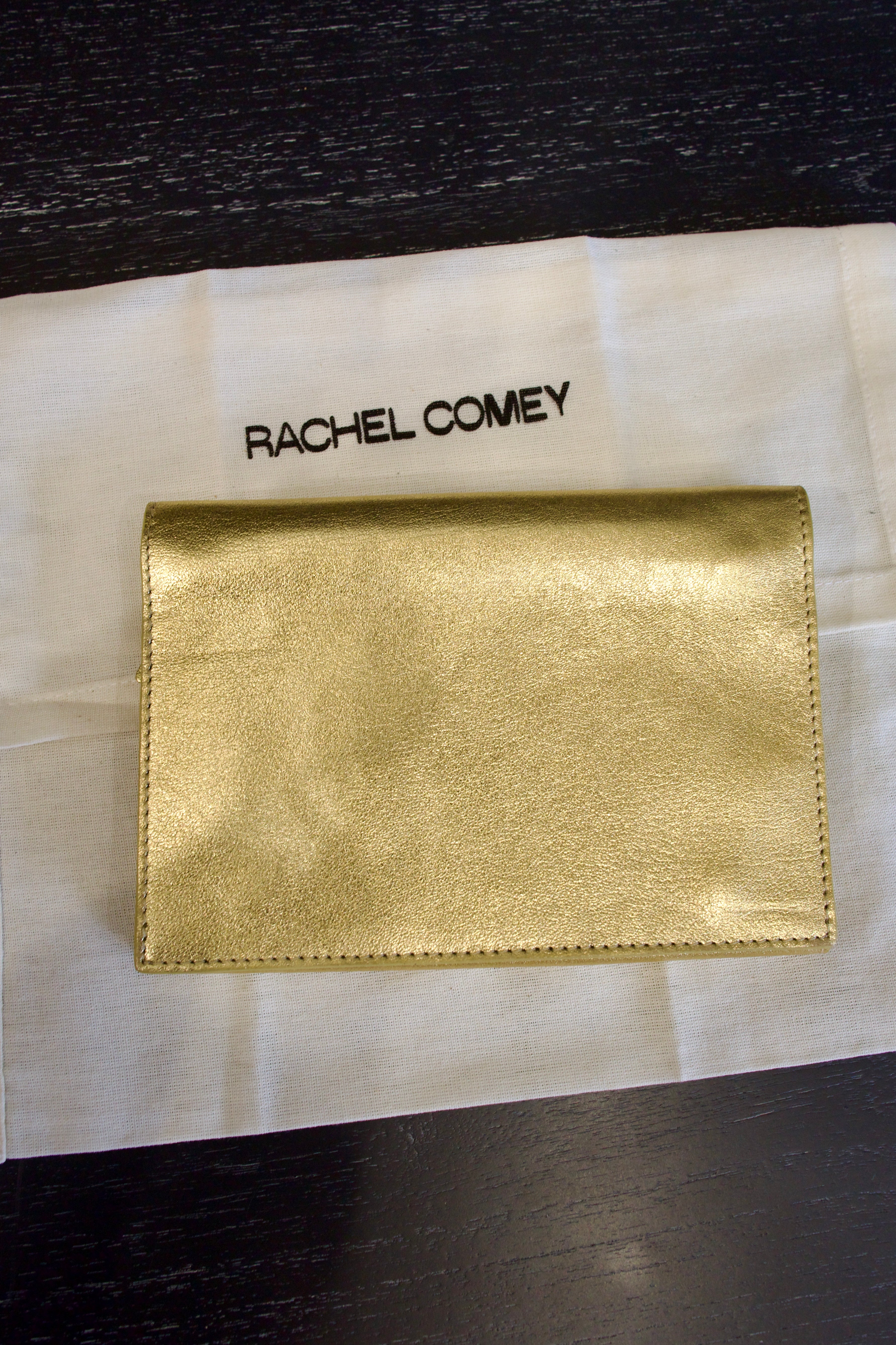 Photo of a gold metallic Rachel Comey leather jewelry travel case with multiple storage compartments 