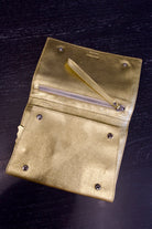 Photo of a gold metallic Rachel Comey leather jewelry travel case with multiple storage compartments 