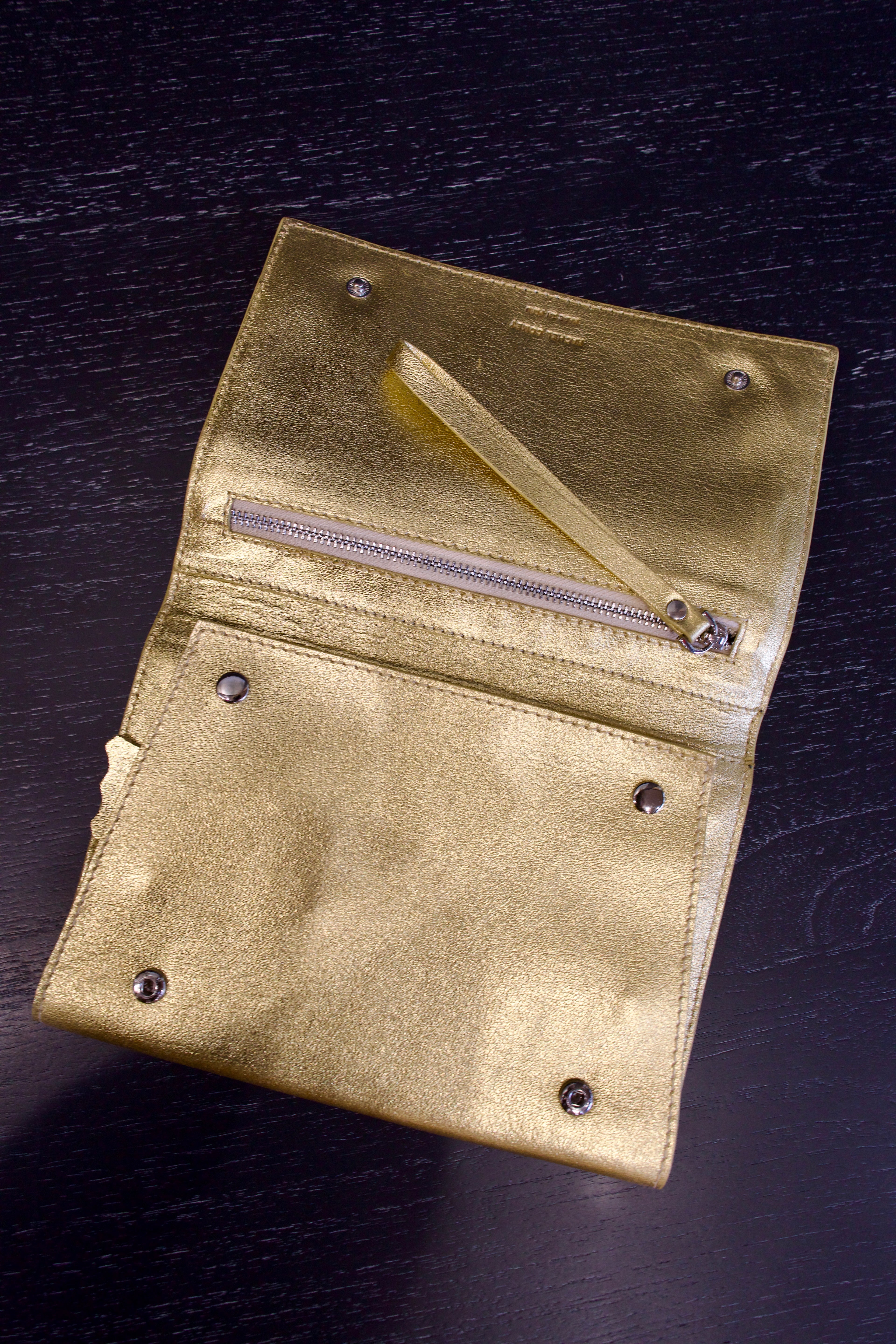 Photo of a gold metallic Rachel Comey leather jewelry travel case with multiple storage compartments 