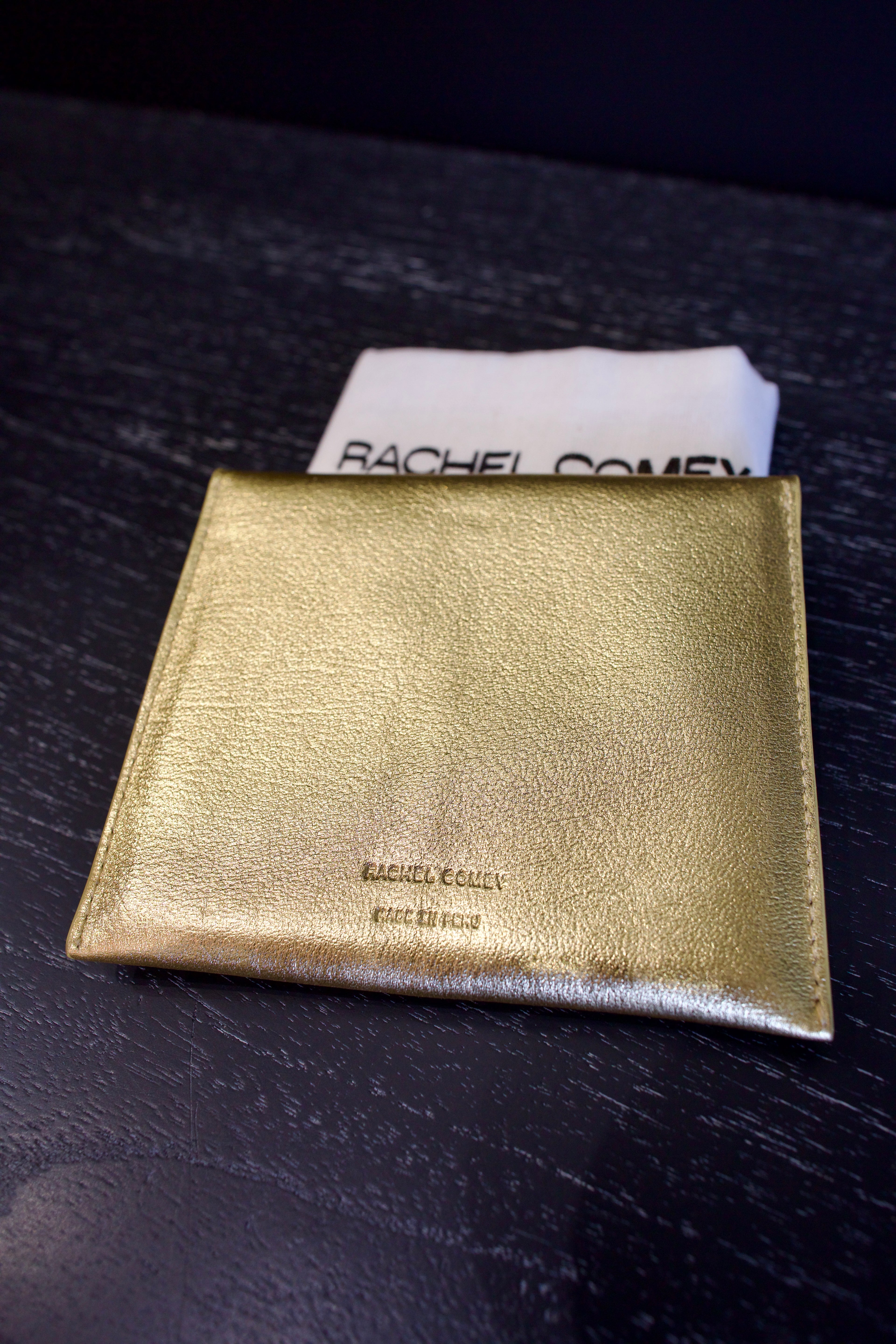 Metallic gold Rachel Comey leather wallet with two snap buttons closure