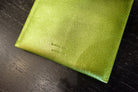 Lime green Rachel Comey leather wallet with two snap buttons closure