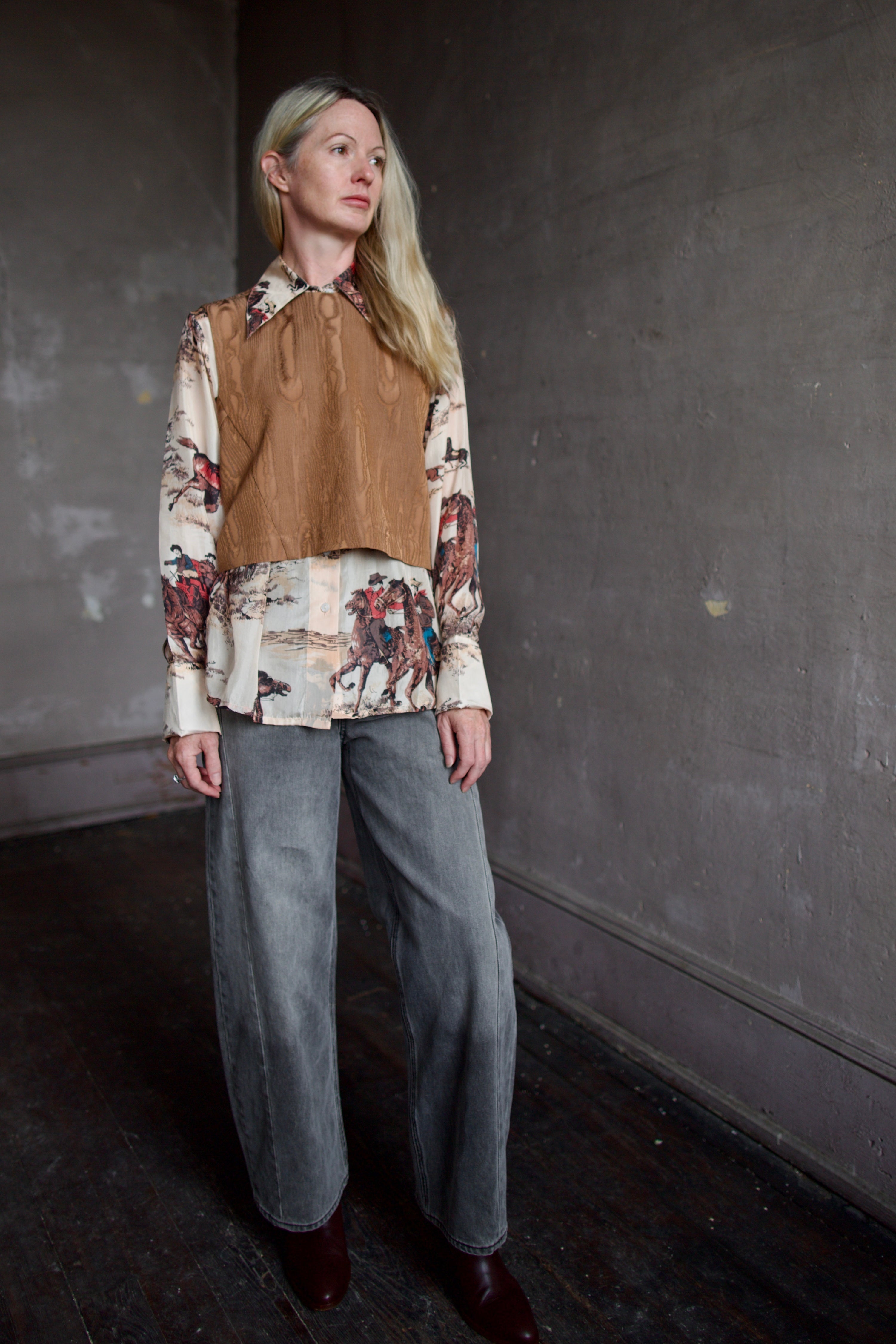 Model wearing a brown faux boise patterned top by designer Rachel Comey layered over a button down