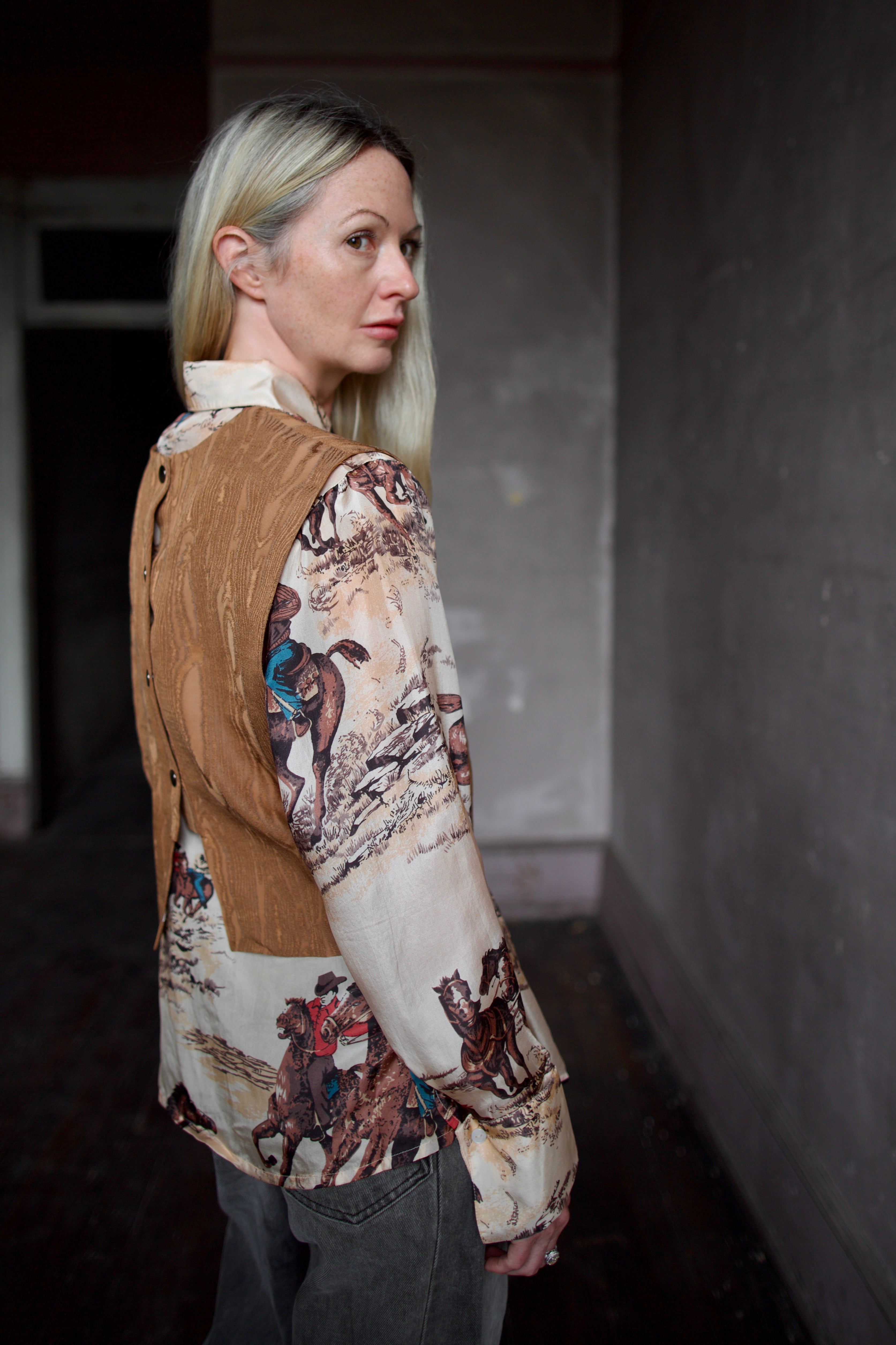 Model wearing a brown faux boise patterned top by designer Rachel Comey layered over a button down