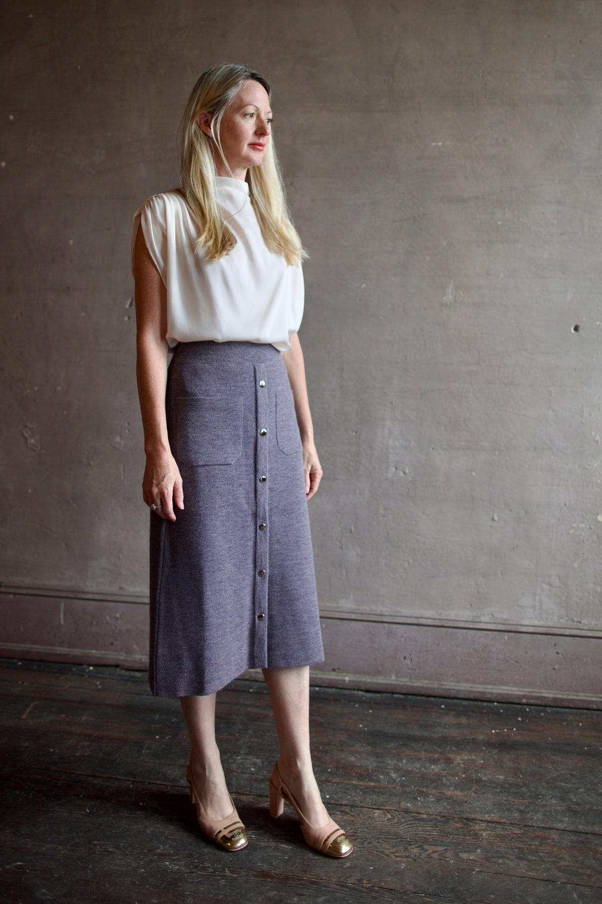 Mature model wearing a quality lilac knit skirt fabricated from baby alpaca by designer Rachel Comey