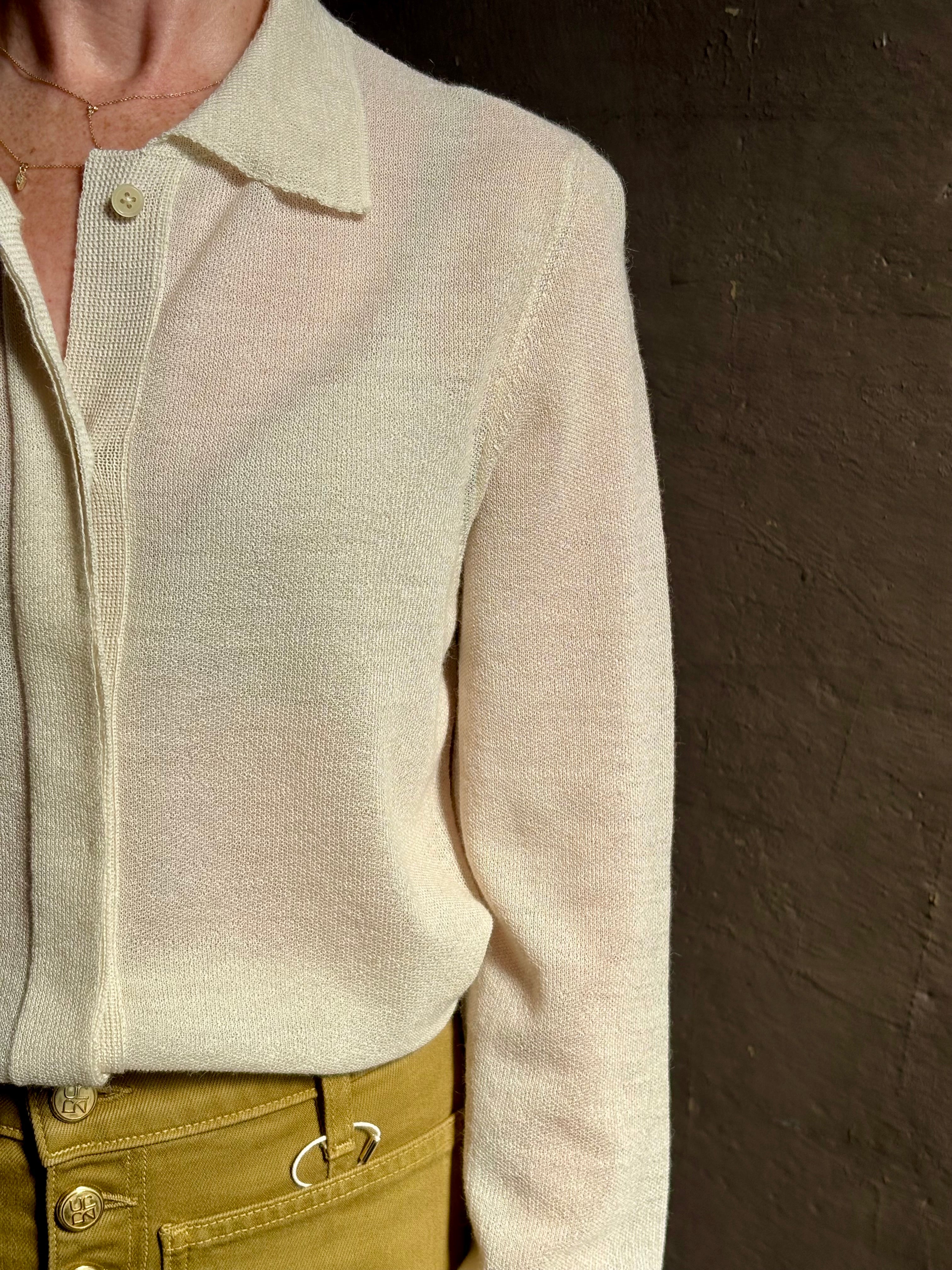 Mature woman wearing Premium Baby Alpaca Mulberry Silk Calma shirt by Rachel Comey with button front, long sleeves and collar rendered in cream