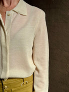 Mature woman wearing Premium Baby Alpaca Mulberry Silk Calma shirt by Rachel Comey with button front, long sleeves and collar rendered in cream