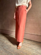 Mature woman wearing premium wool silk  women's designer Rachel Comey Cosa maxi Skirt with tailored waistband, belt loops and back vent rendered in a vibrant warm pink hue