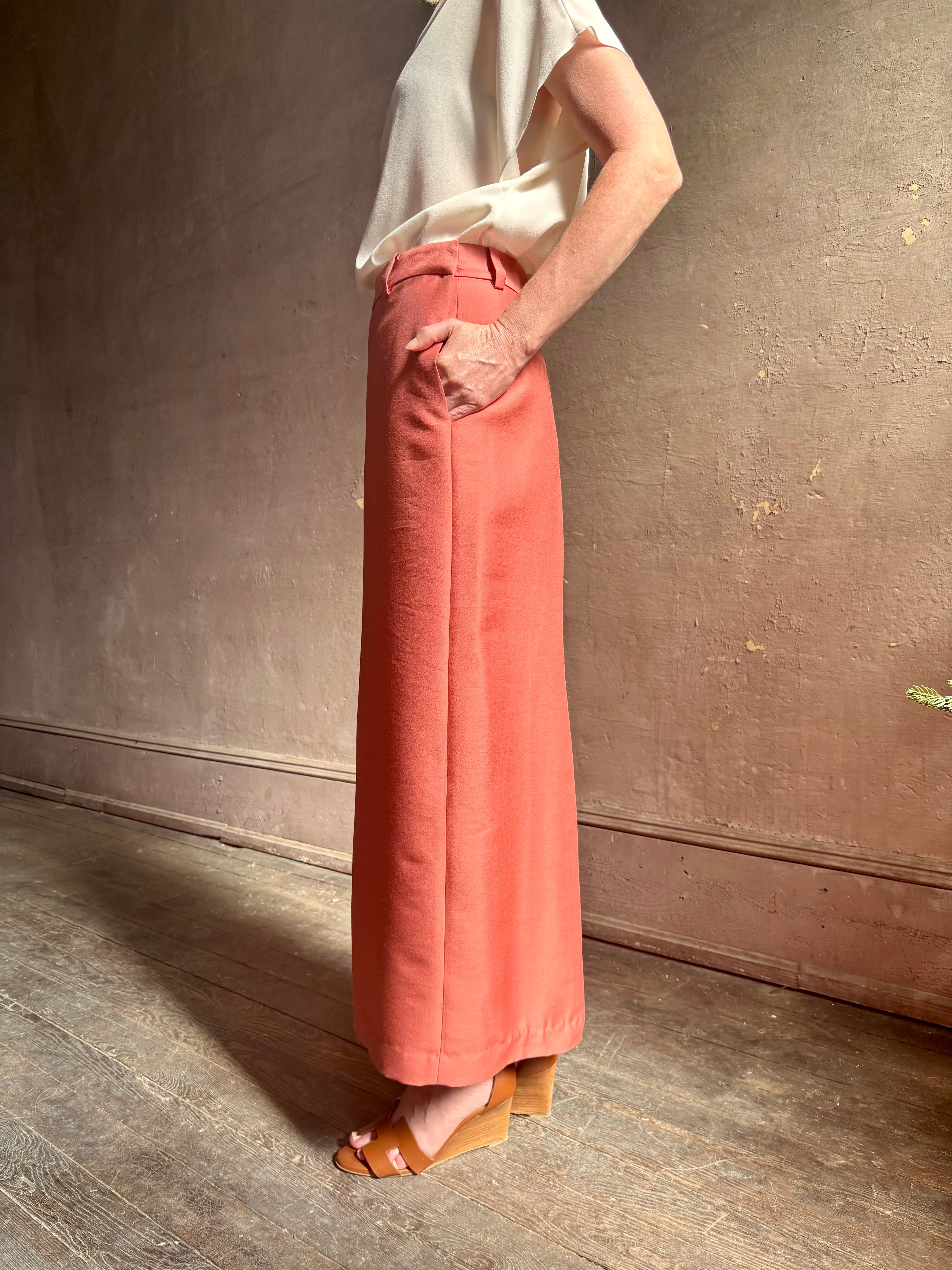 Mature woman wearing premium wool silk  women's designer Rachel Comey Cosa maxi Skirt with tailored waistband, belt loops and back vent rendered in a vibrant warm pink hue