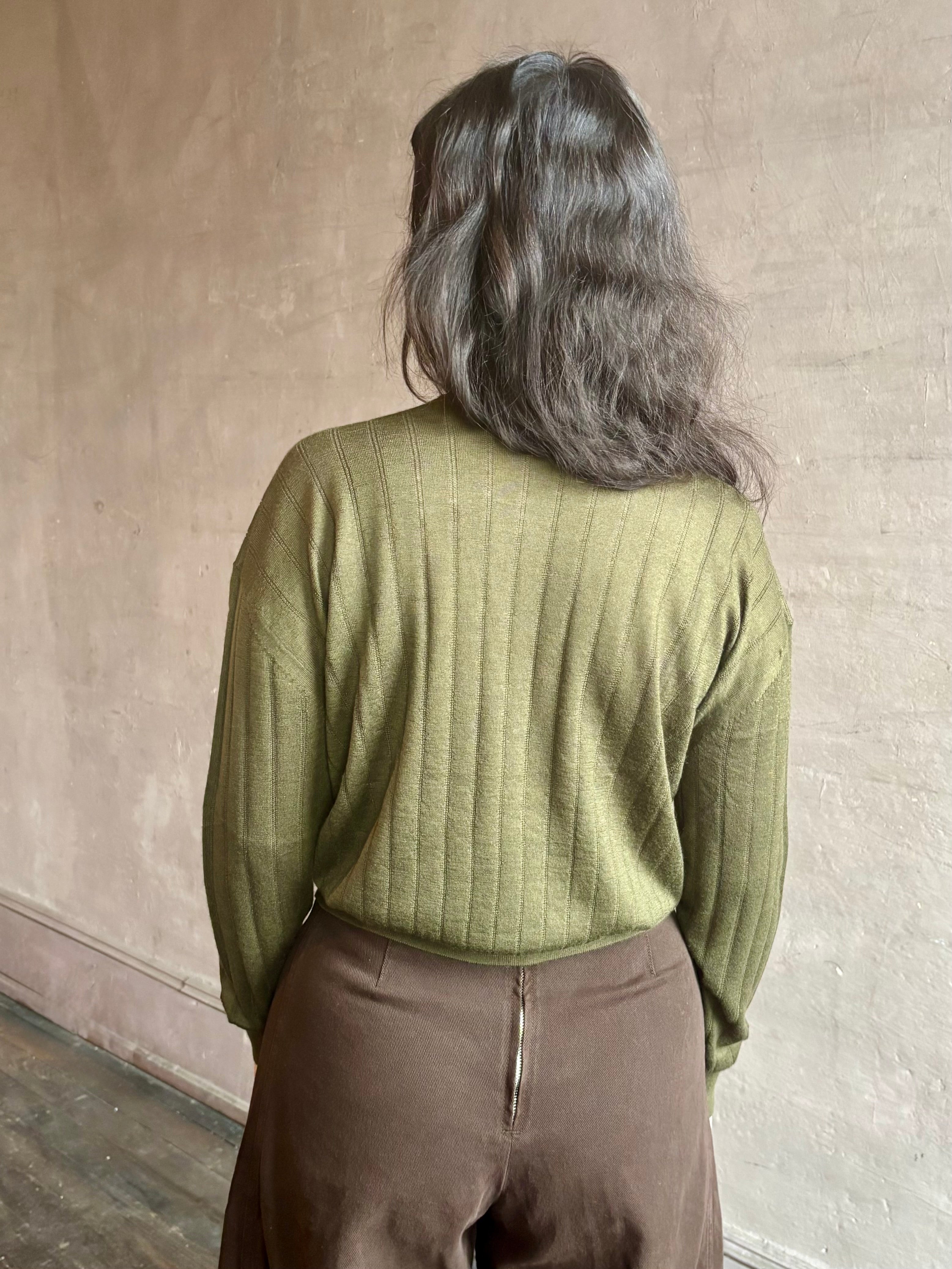Image of woman wearing luxury Cashmere Silk Marion V-Neck designer Sweater by Rachel Comey in olive green with long sleeves and linear weave