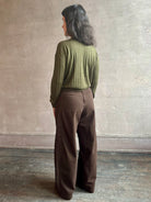 Image of woman wearing luxury Cashmere Silk Marion V-Neck designer Sweater by Rachel Comey in olive green with long sleeves and linear weave