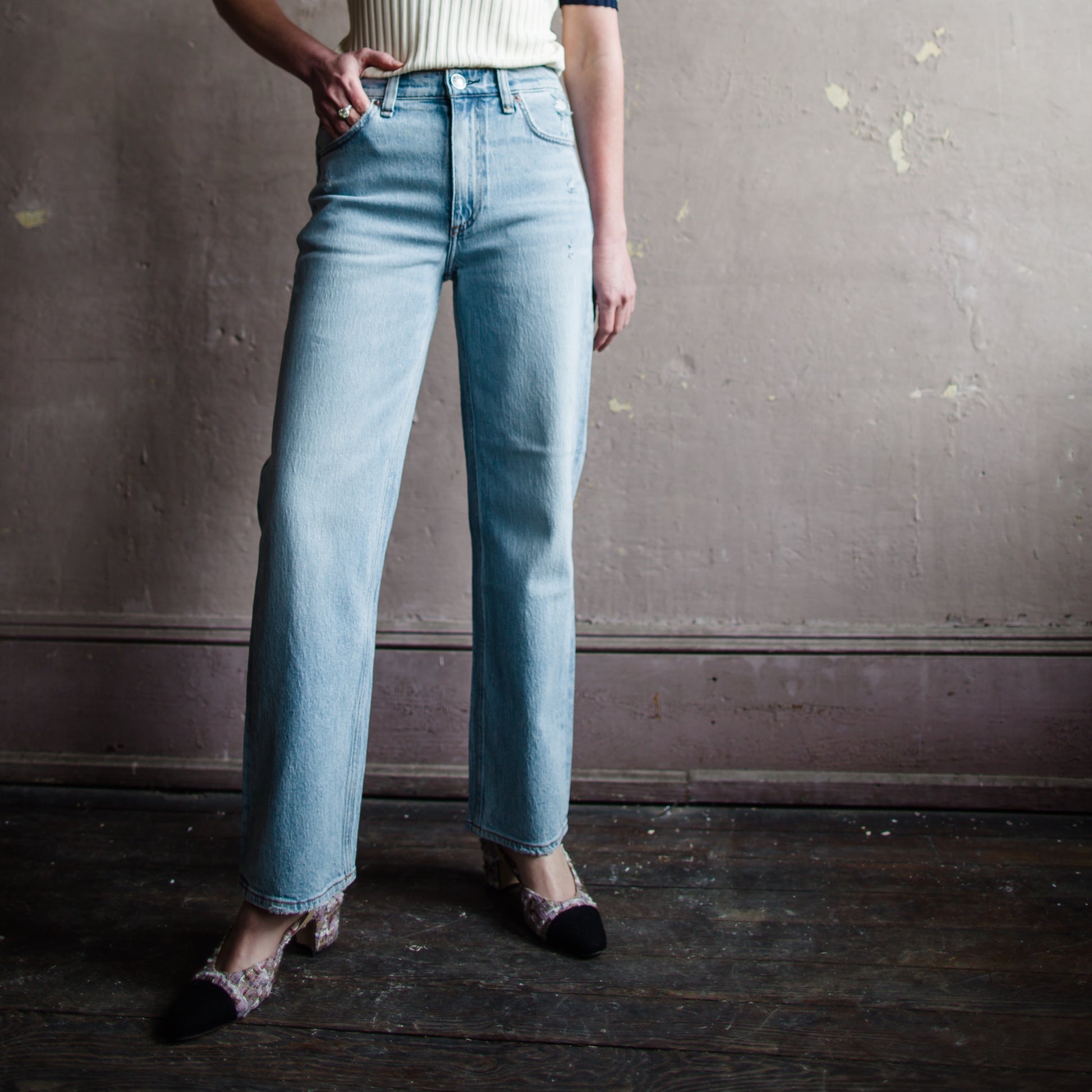 Image featuring a woman wearing  Rag & Bone Harlow denim with straight leg, mid-rise style that's fitted through the thigh crafted from stretch denim, ankle length jean.