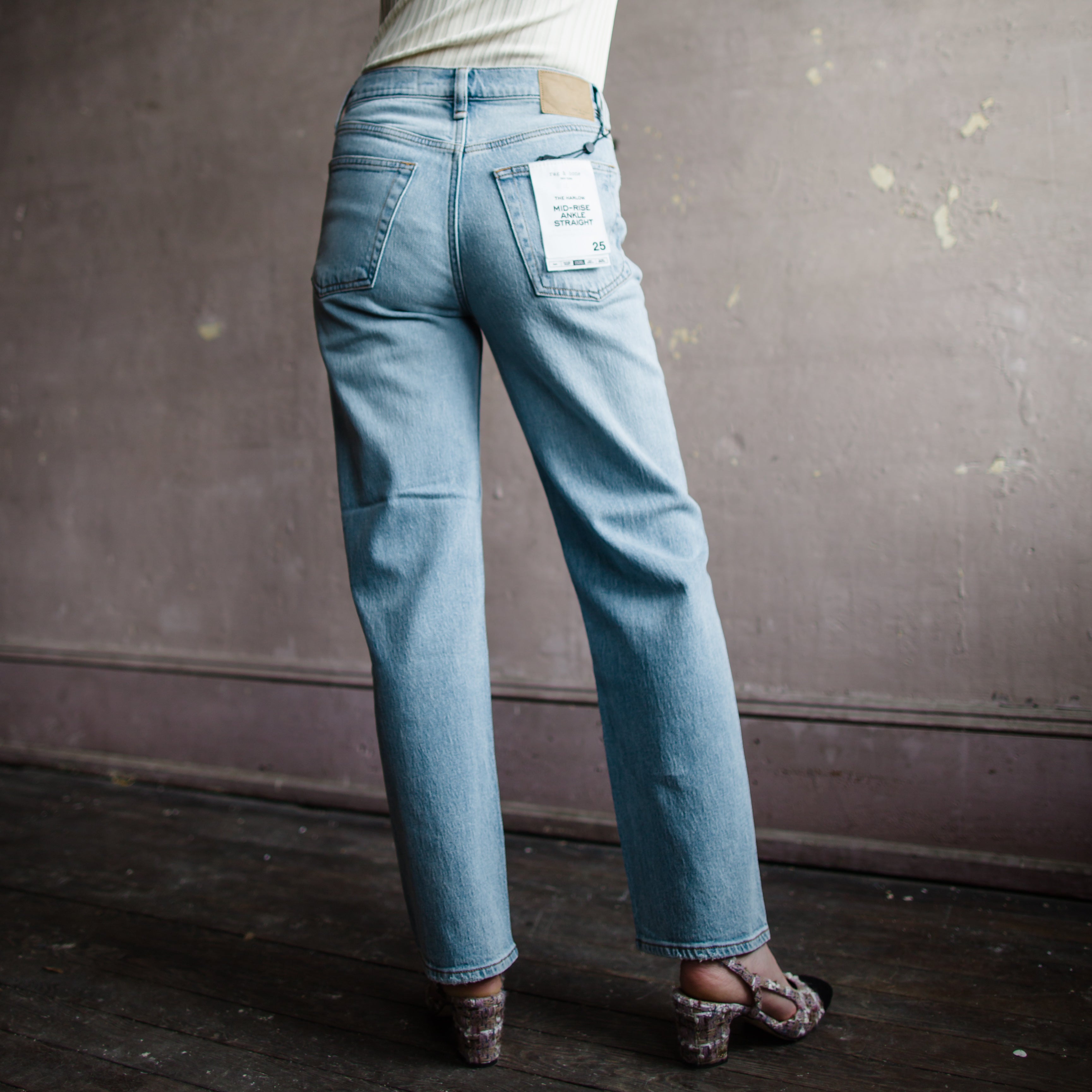 Image featuring a woman wearing  Rag & Bone Harlow denim with straight leg, mid-rise style that's fitted through the thigh crafted from stretch denim, ankle length jean.