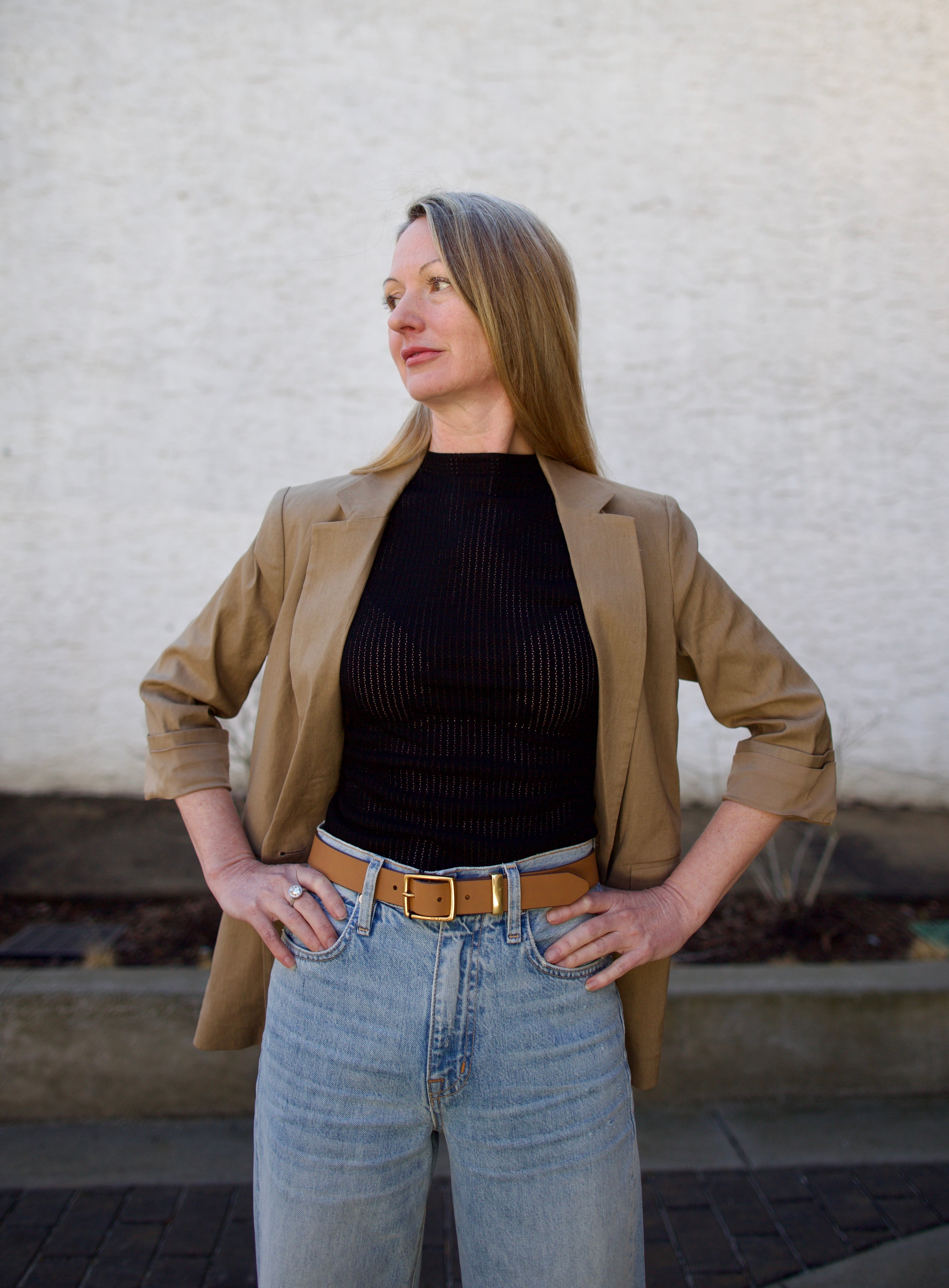 Woman wearing the Rag and Bone Molly Mock Neck black Top in semi-sheer knit construction and expertly designed minimalist silhouette