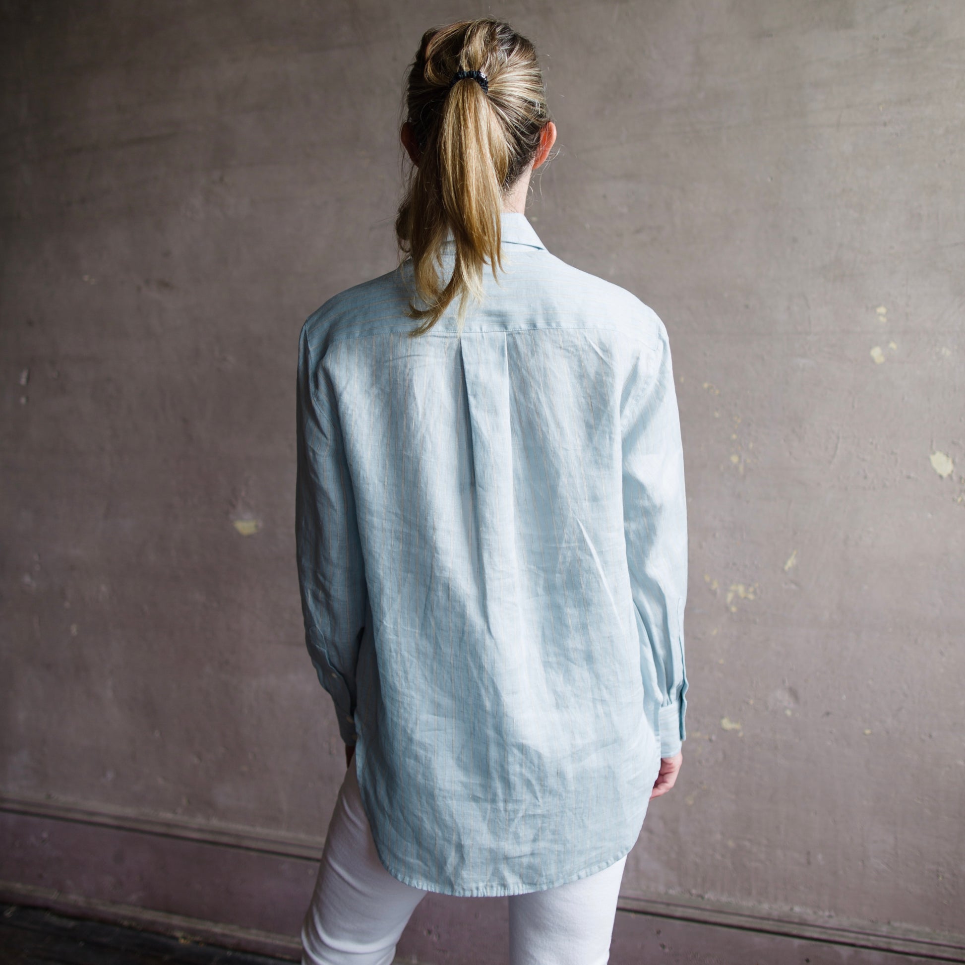 The Maxine Button Down Shirt from Rag & Bone in striped linen and featuring; horn buttons, a box pleat at the center back, and a high-low hem.