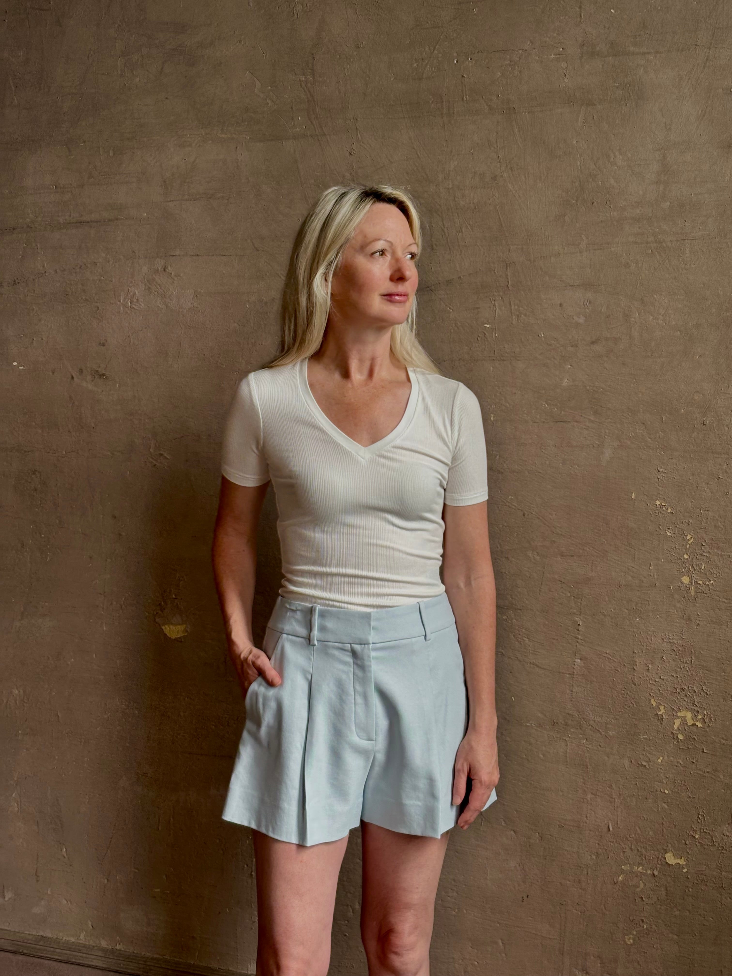 Mature woman wearing the Rag & Bone Luca T-shirt with a rib-knit, V-neck and classic short sleeves in white