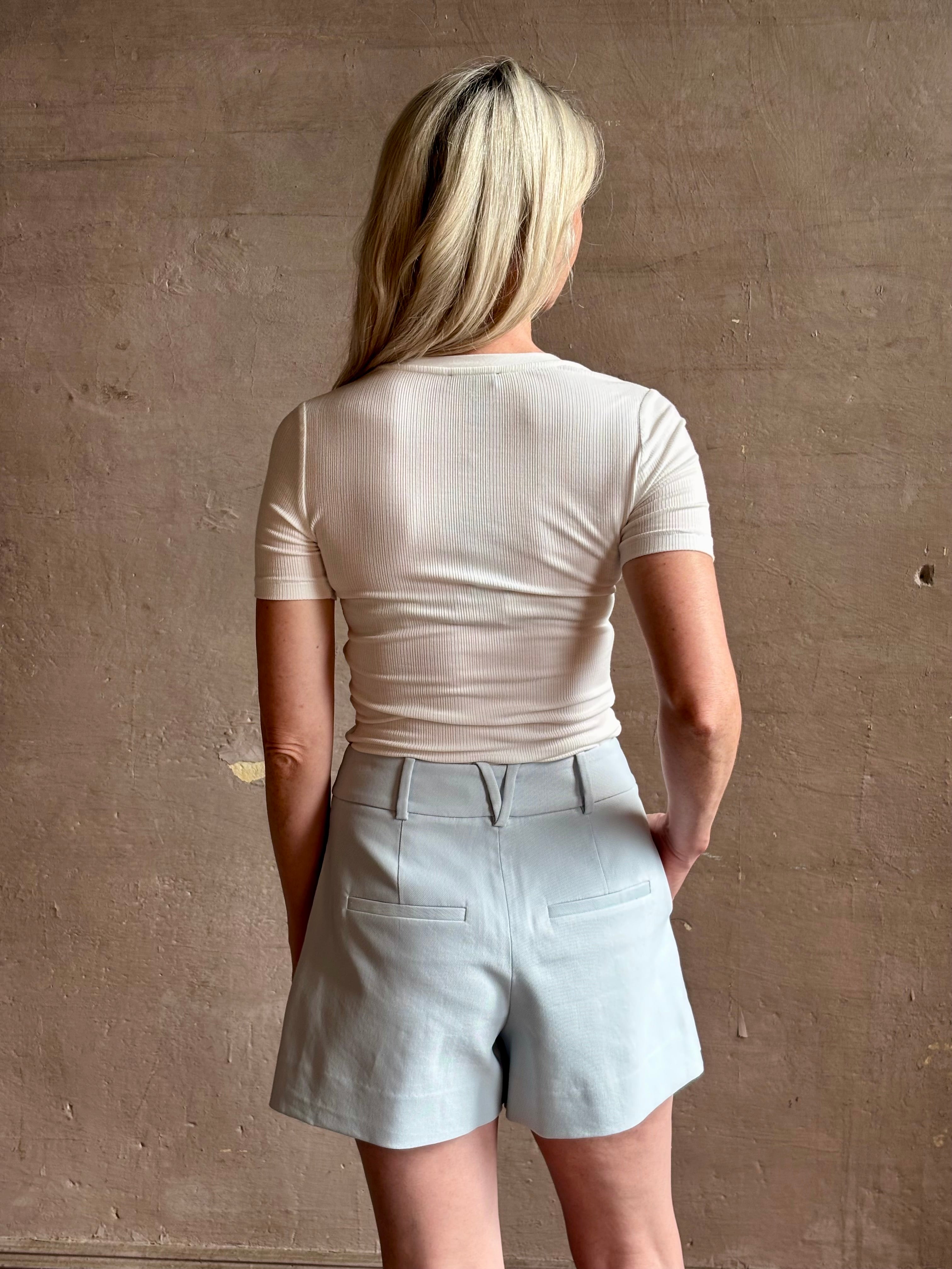 Mature woman wearing the Rag & Bone Luca T-shirt with a rib-knit, V-neck and classic short sleeves in white