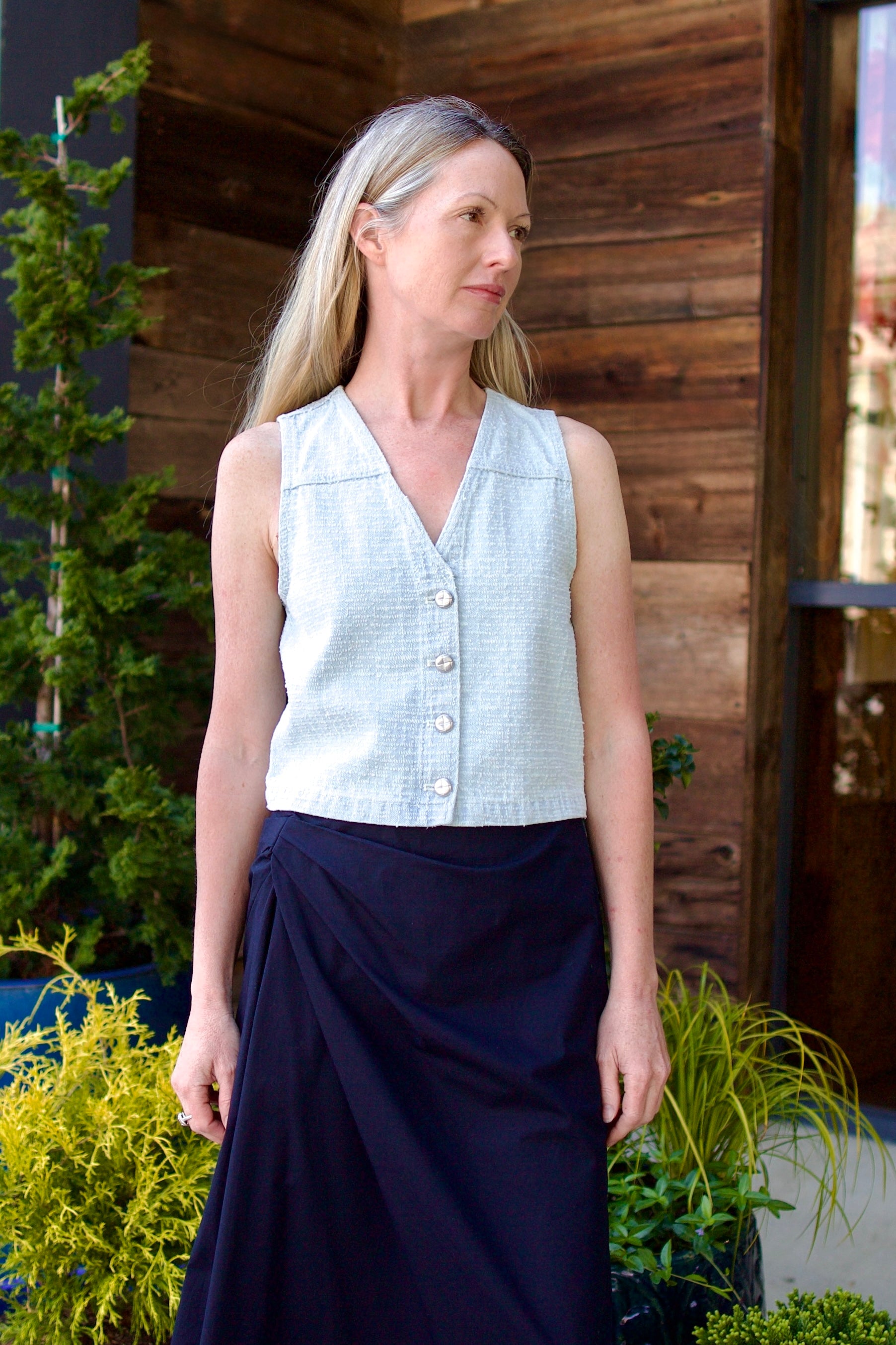 Image of model wearing the Rag & Bone Juliana Tweed Vest and cotton navy blue ALC Skirt with elegant draping