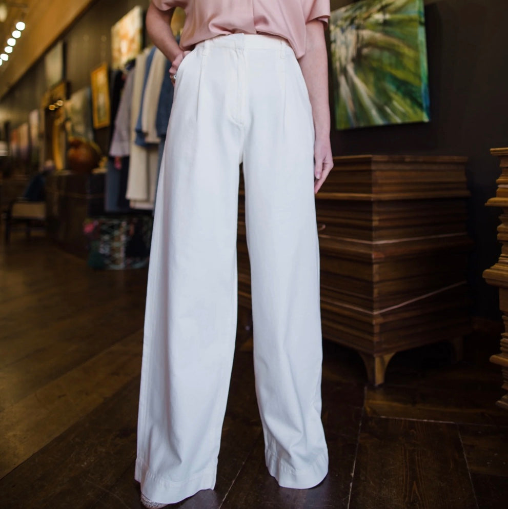 Image featuring a woman wearing Rag & Bone Abigail wide leg trousers with a pleated front and crafted from Featherweight denim.