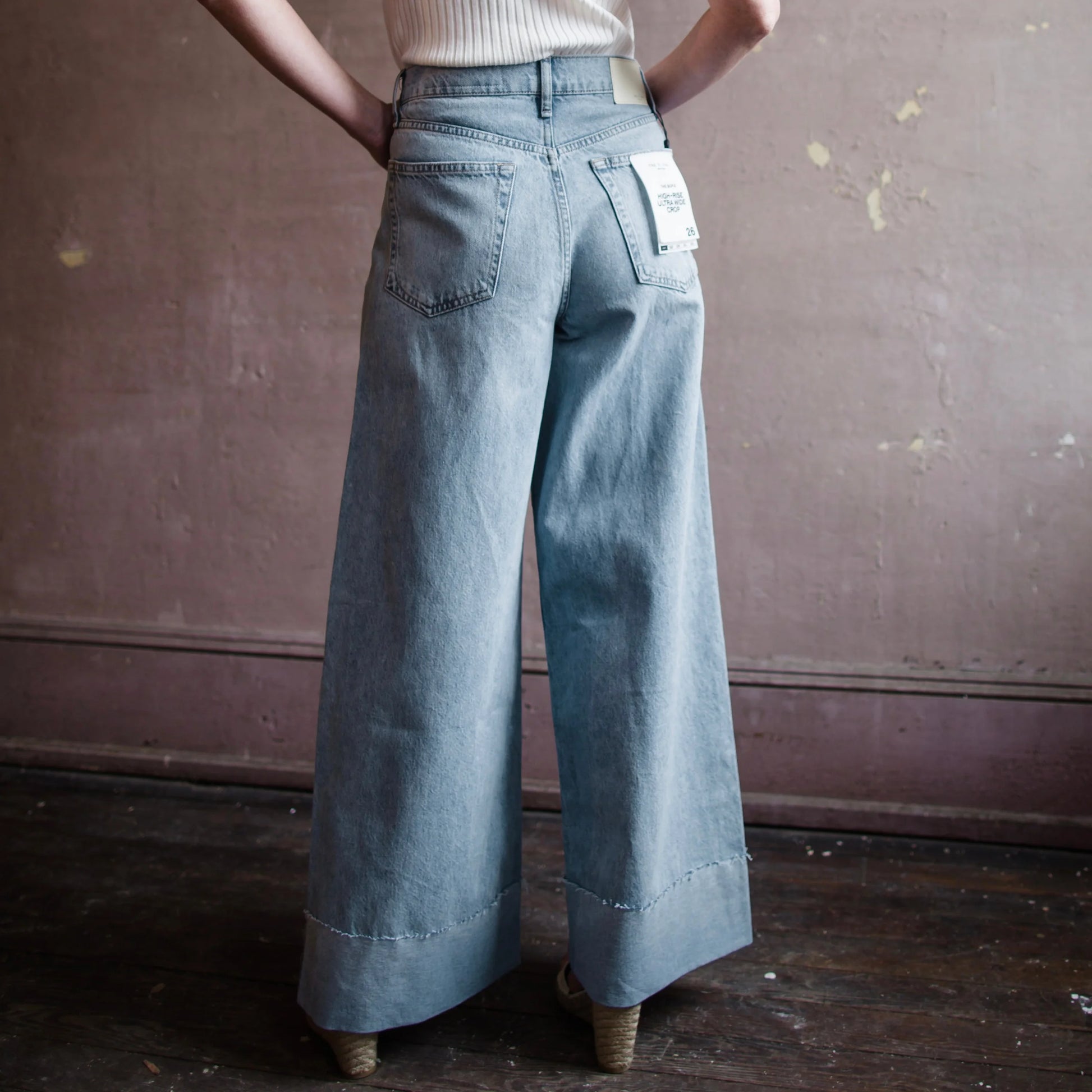 Image featuring a woman wearing the Rag & Bone Sofie denim with a cropped wide leg jean and Cuffed bottom.