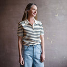 Image featuring a woman wearing the Rag & Bone Viola polo top with striped open knit, short sleeve, and V-neck button front.