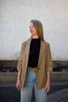 Woman wearing the Rag and Bone Molly Mock Neck black Top in semi-sheer knit sleeveless stretchy knit for close fit