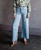 Image featuring a woman wearing the rigid jeans by Re/Done with a mid rise, cropped, wide leg in the Marea wash.